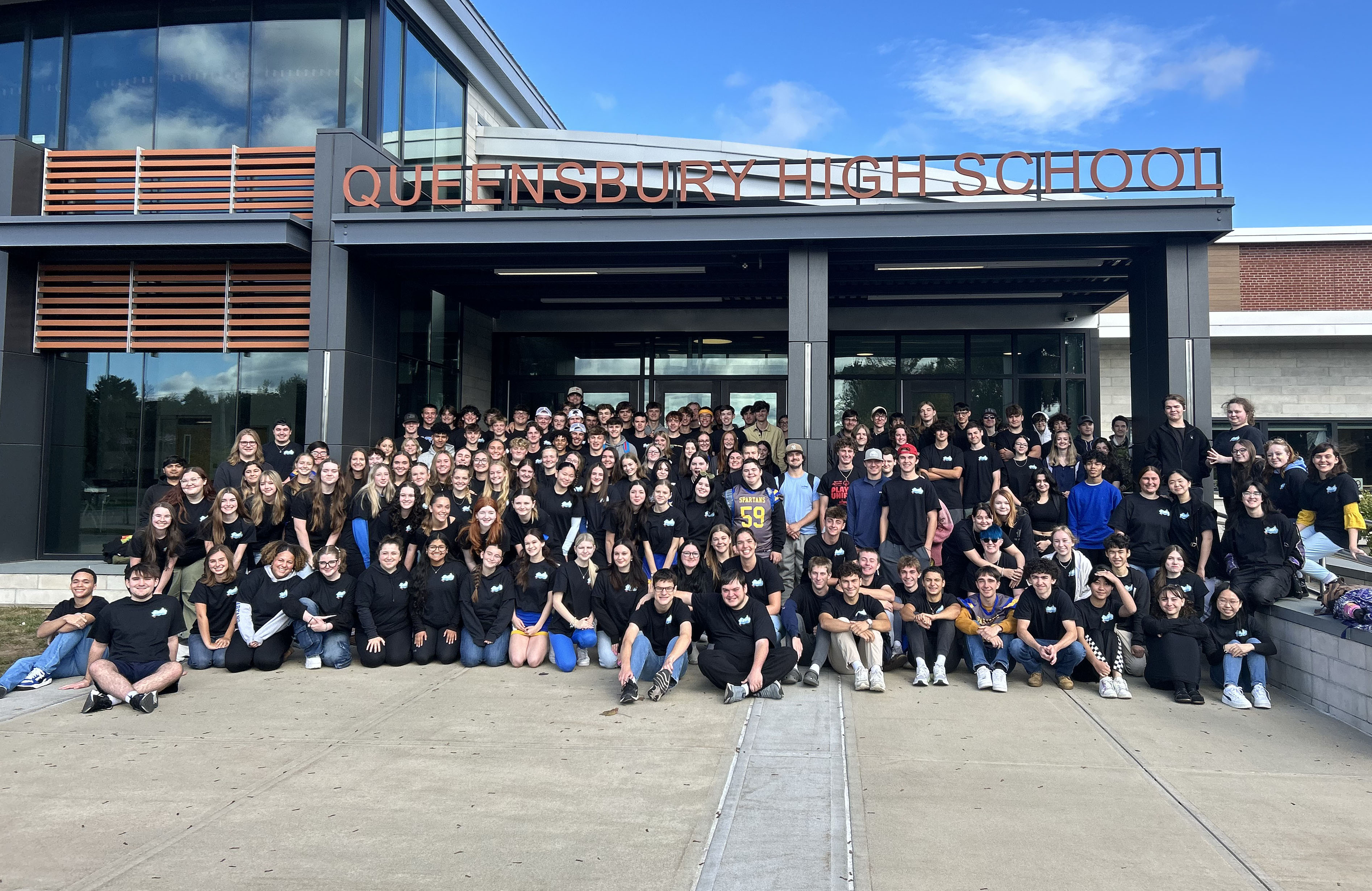 Photo of Class of 2025 outside high school building.