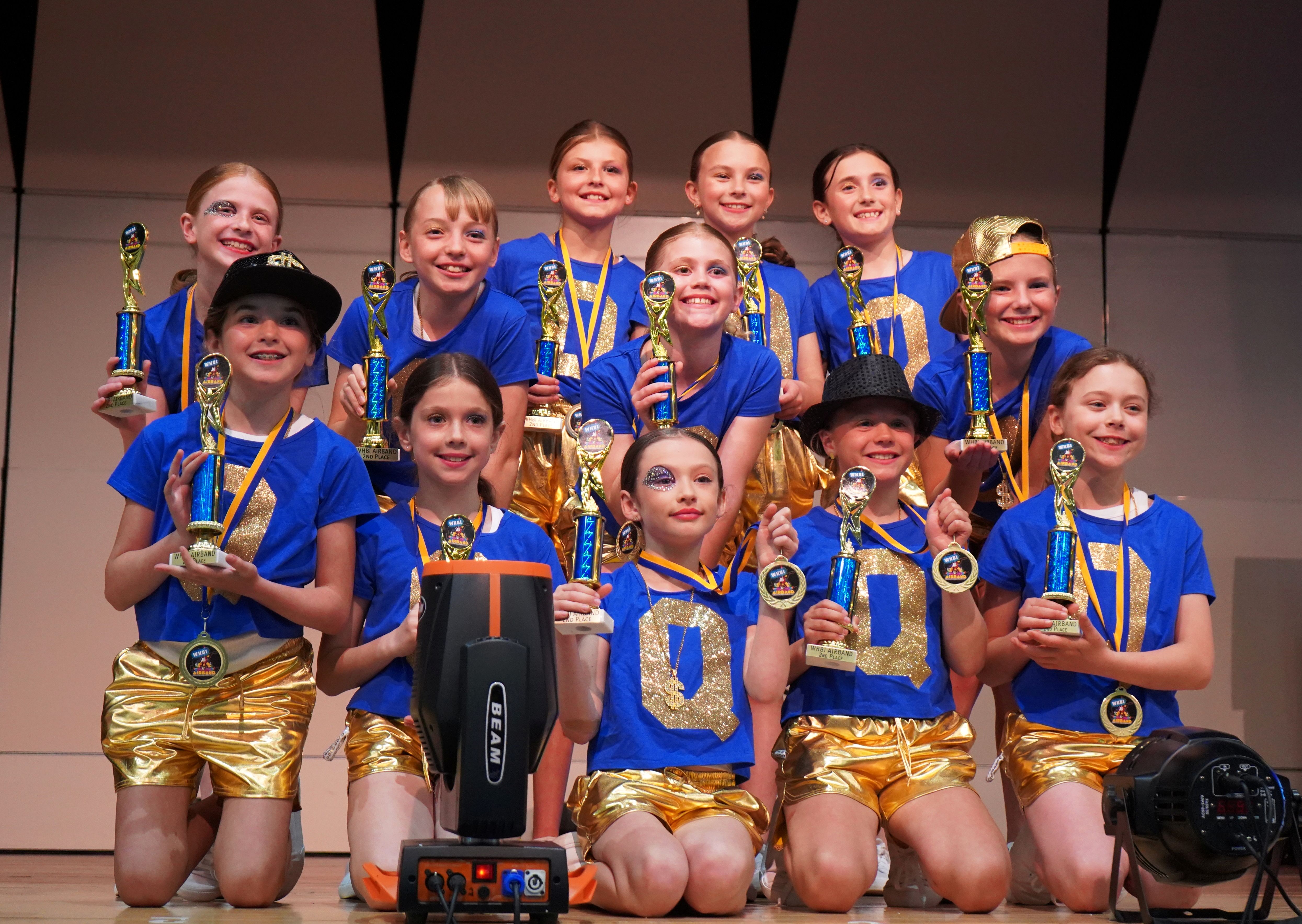 Airband group holds trophies for photo.