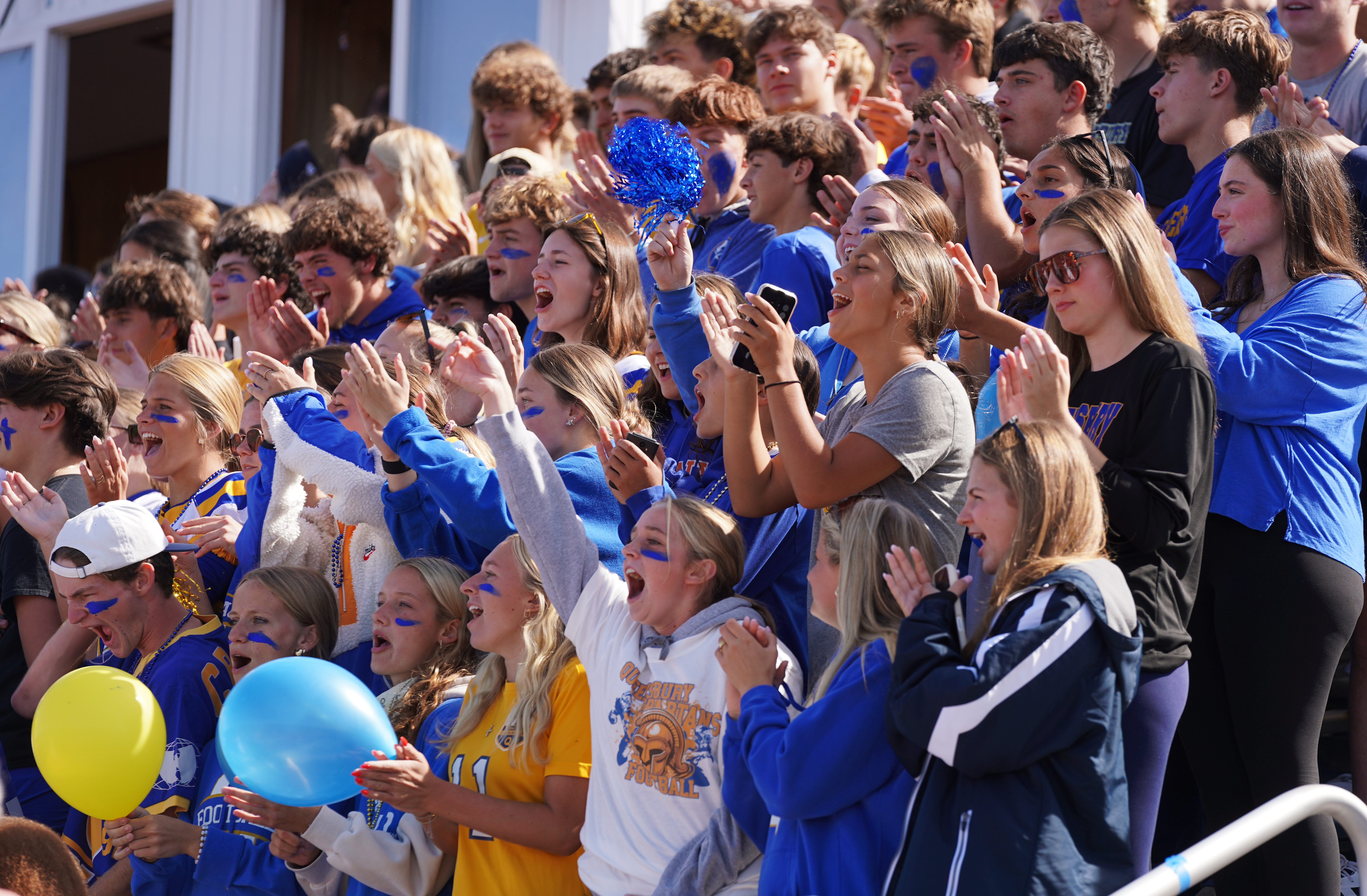 Students cheer at Homecoming football game.