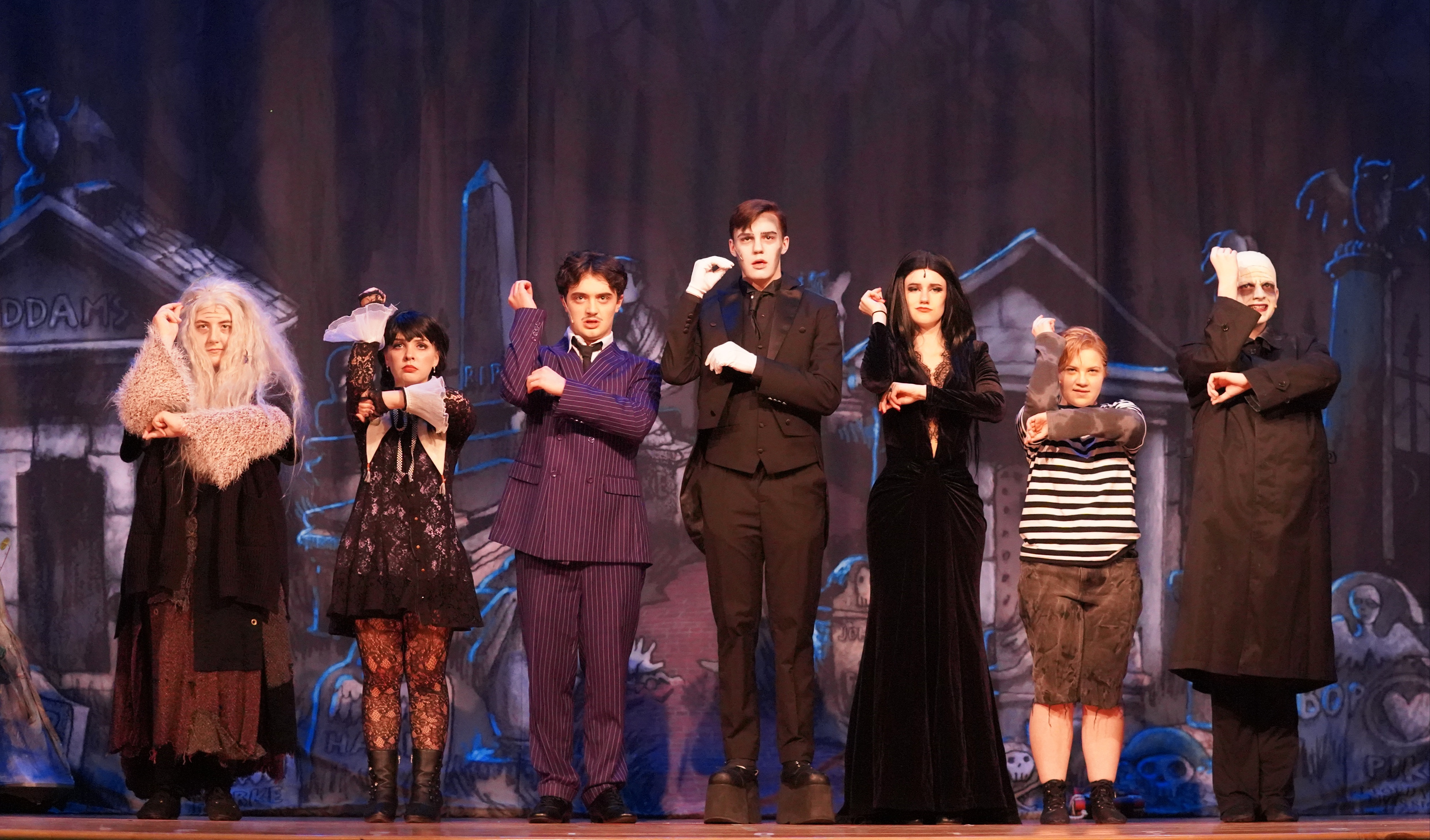The cast of The Addams Family on stage.