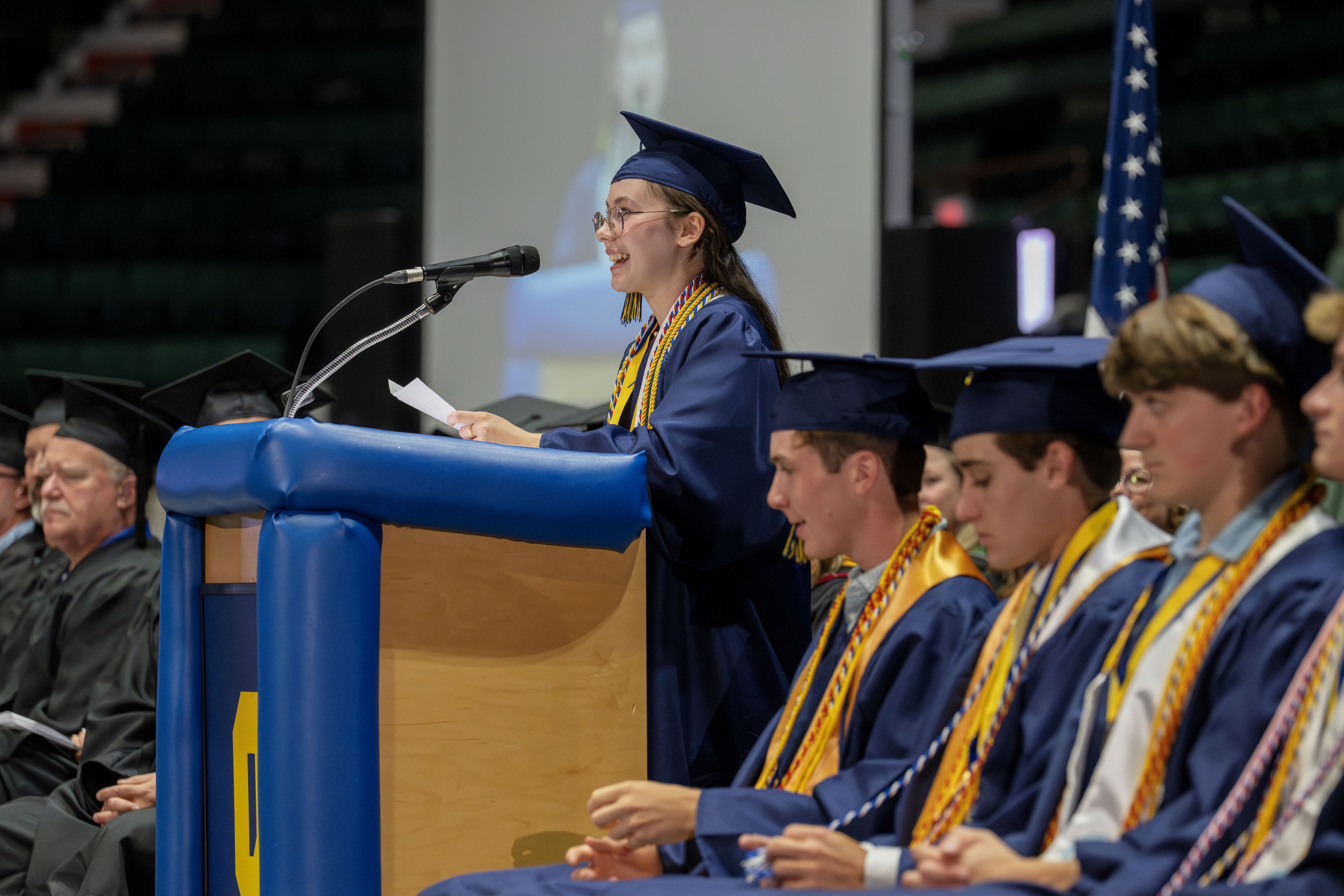 Graduate speaks during graduation ceremony.