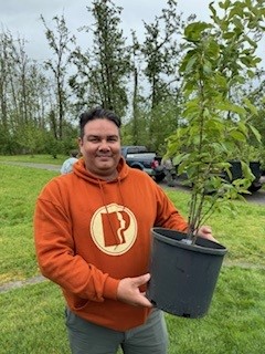 Image of a citizen with the tree that they won