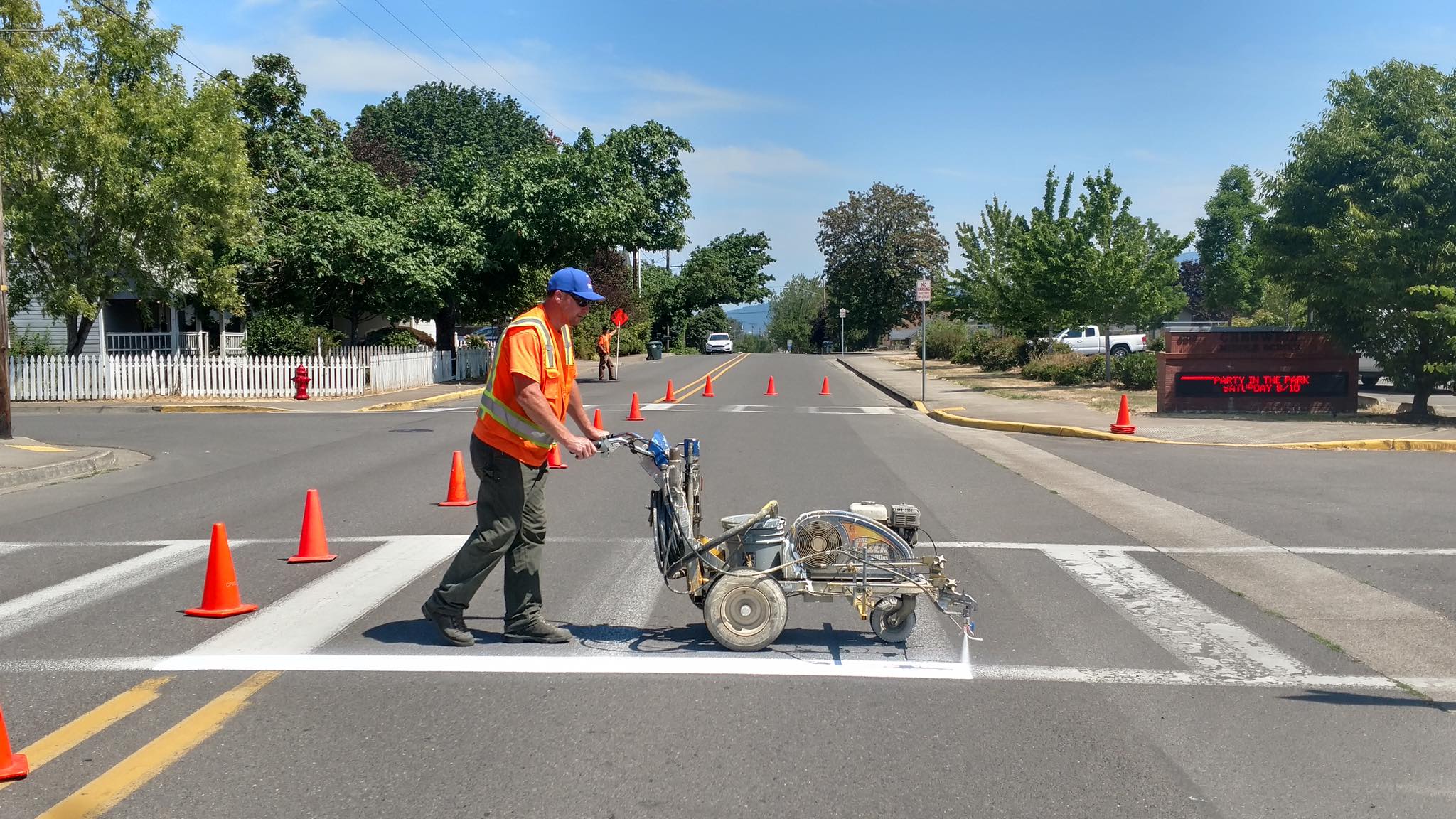 Image of a public works employee painting the street