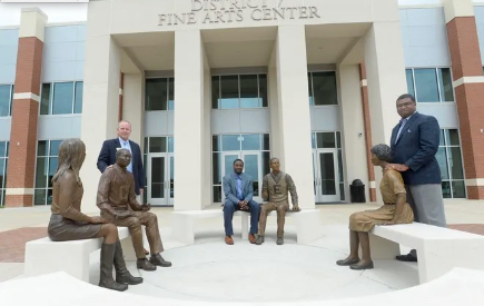 Superintendent of Spartanburg School District Seven Jeff Stevens, Spartanburg High School Principal Vance Jones, and Executive Director elect of the Spartanburg Academic Movement Dr. Russell W. Booker, stand with sculptures to celebrate the 50th anniversary of the school's integration.   