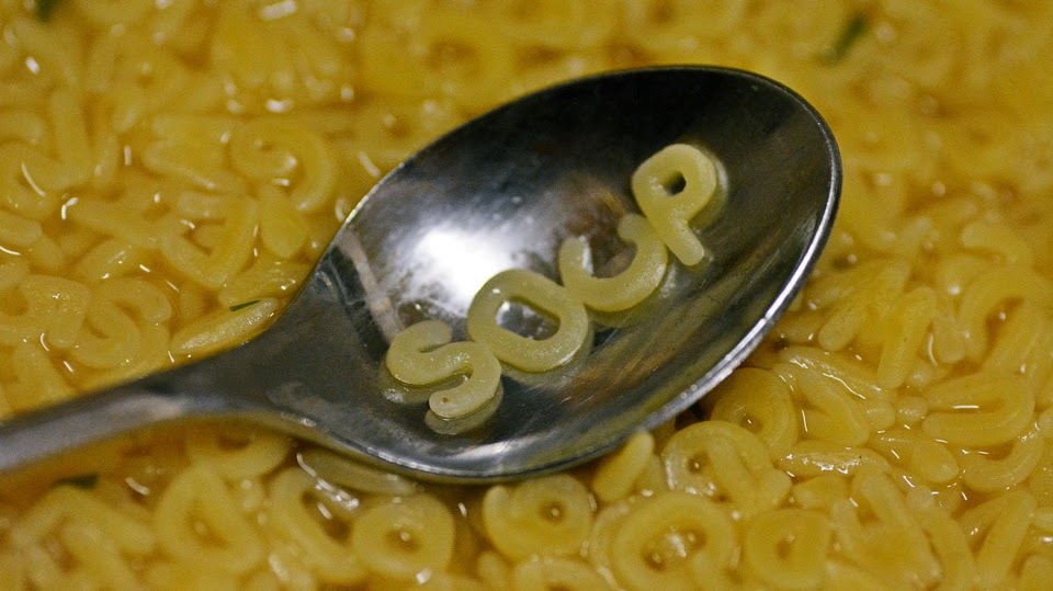 Spoon on letter soup with the word 'soup' on spoon