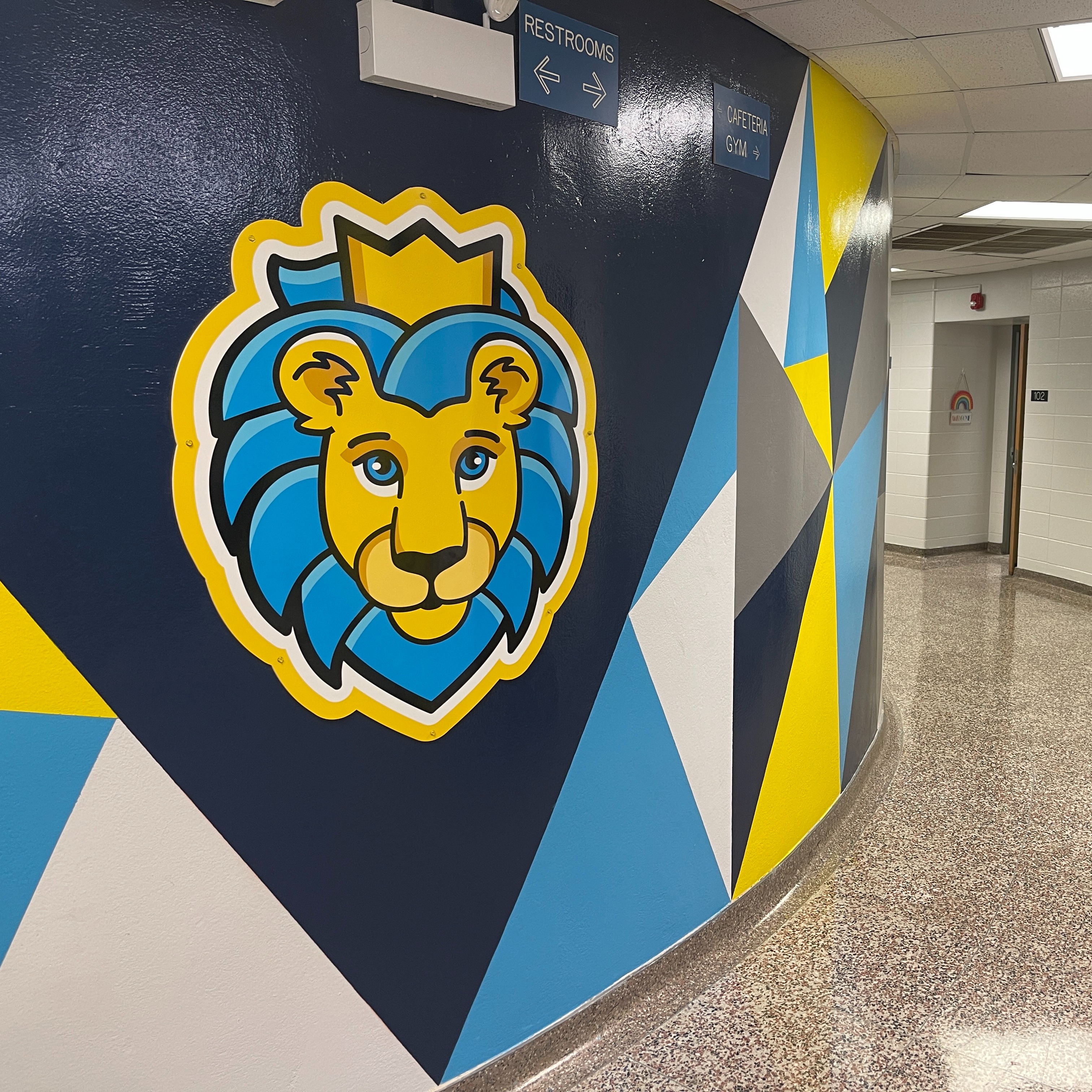 Lion logo on wall in empty school hallway