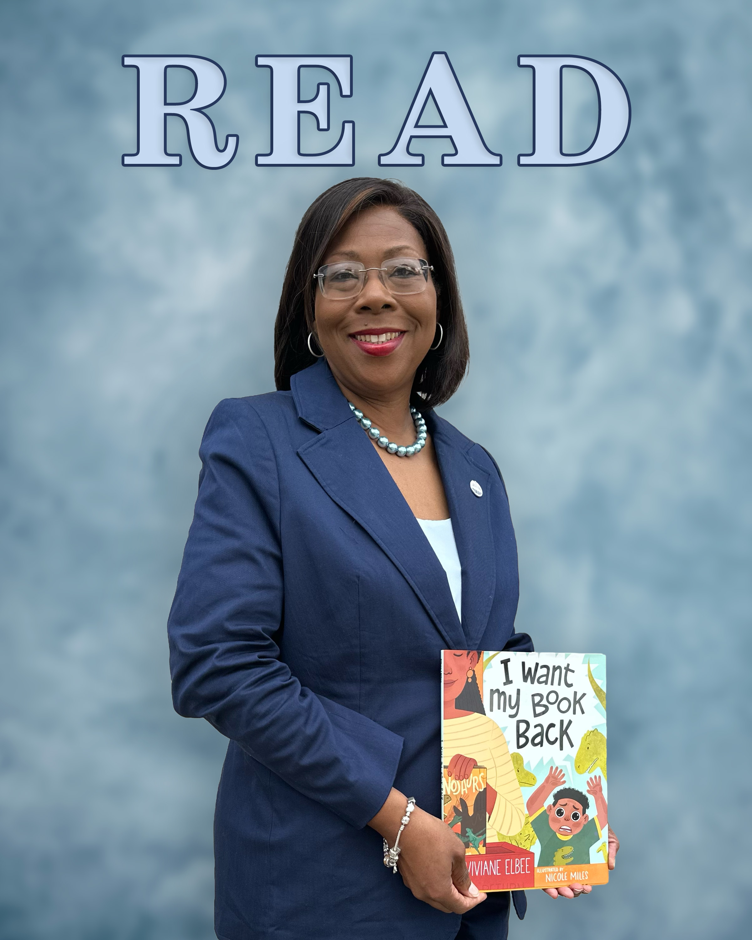 photo of Dr. Reynolds holding a book