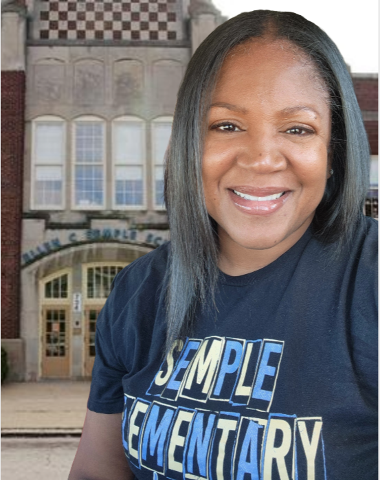 Picture of Black female principal smiling in front of Temple Elementary School.