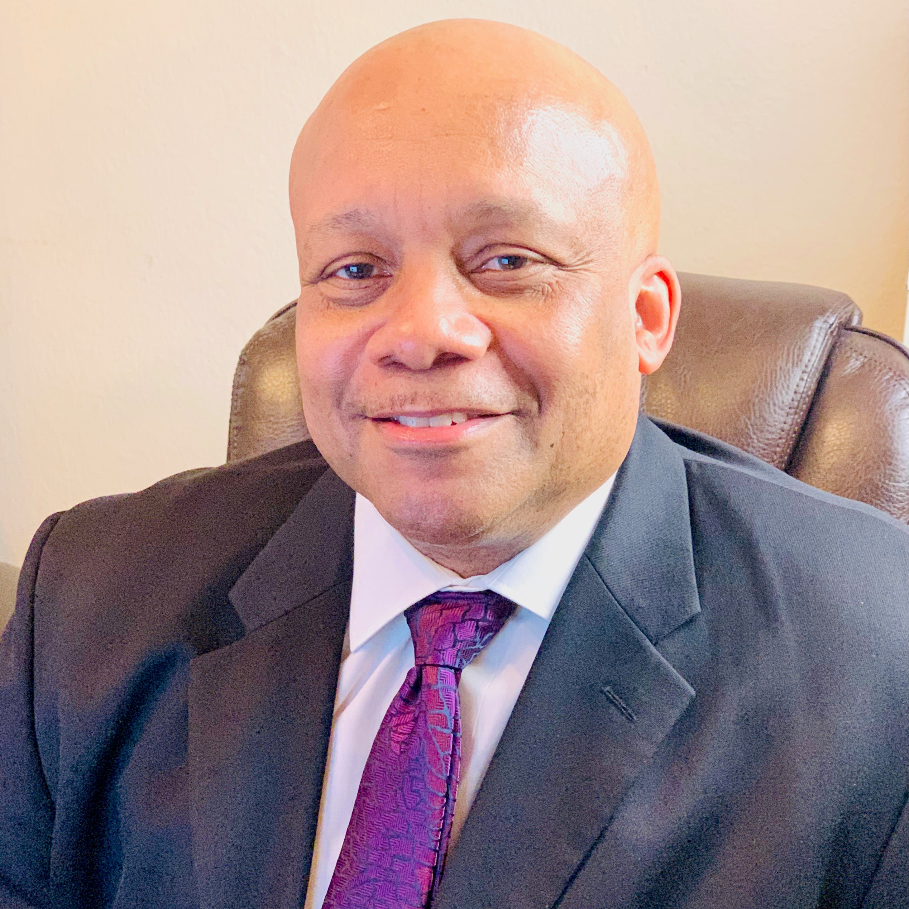 Man smiling in gray suit