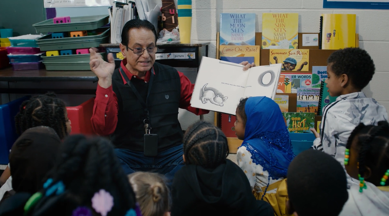 Instructional Assistant reading to students