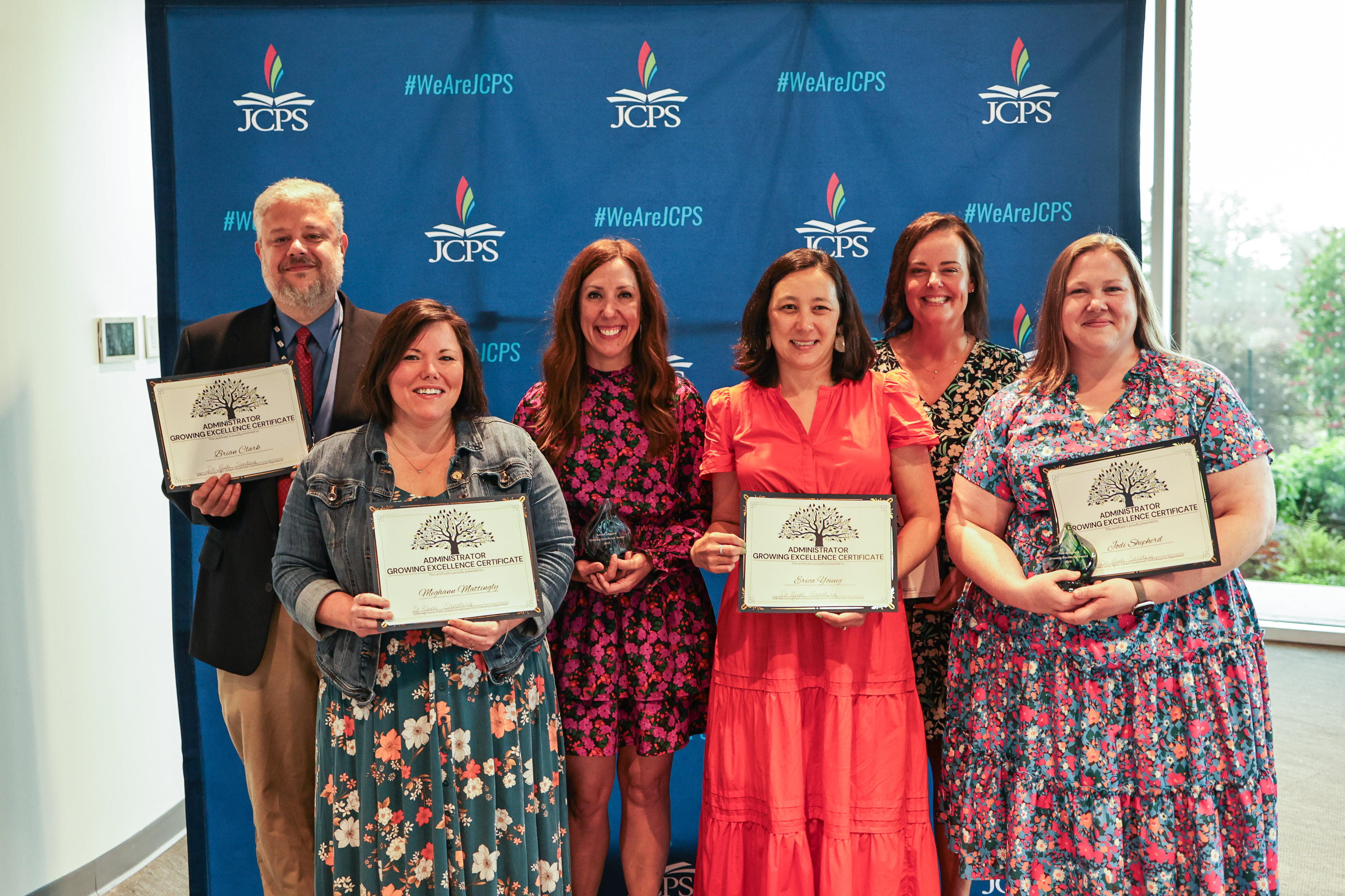 Staff holding awards