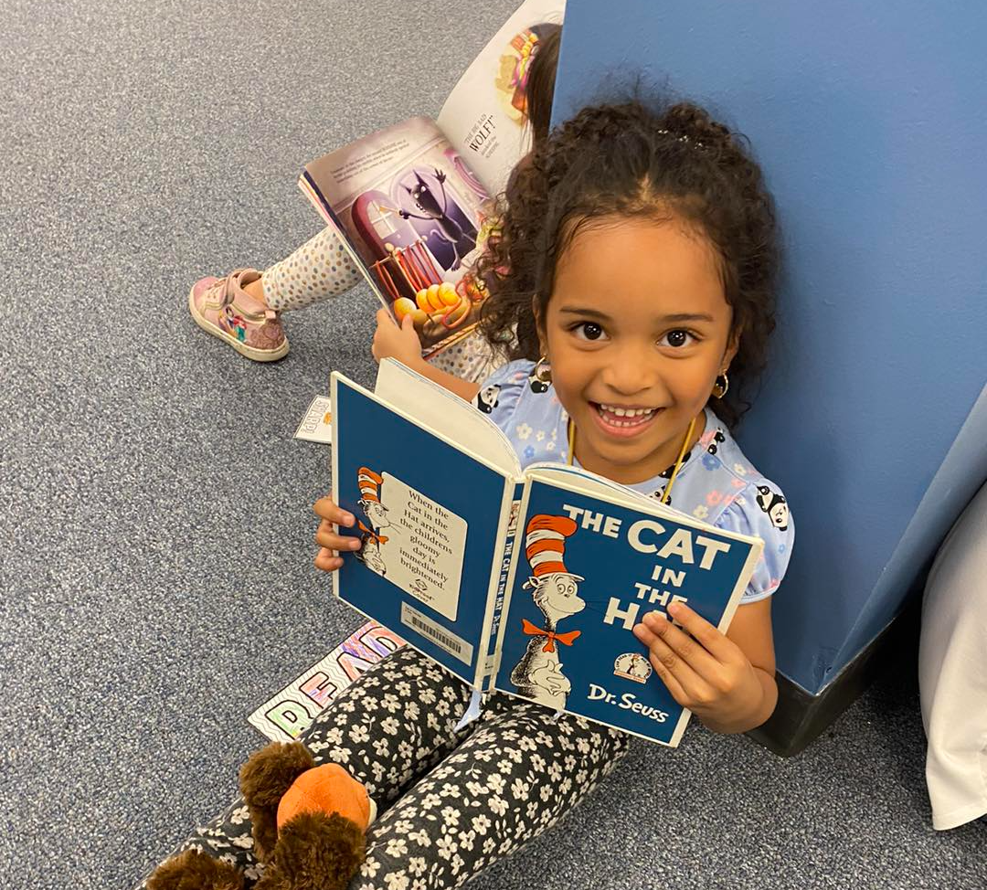 Girl Smiling with Book