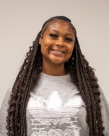 Young woman smiling for photo. 
