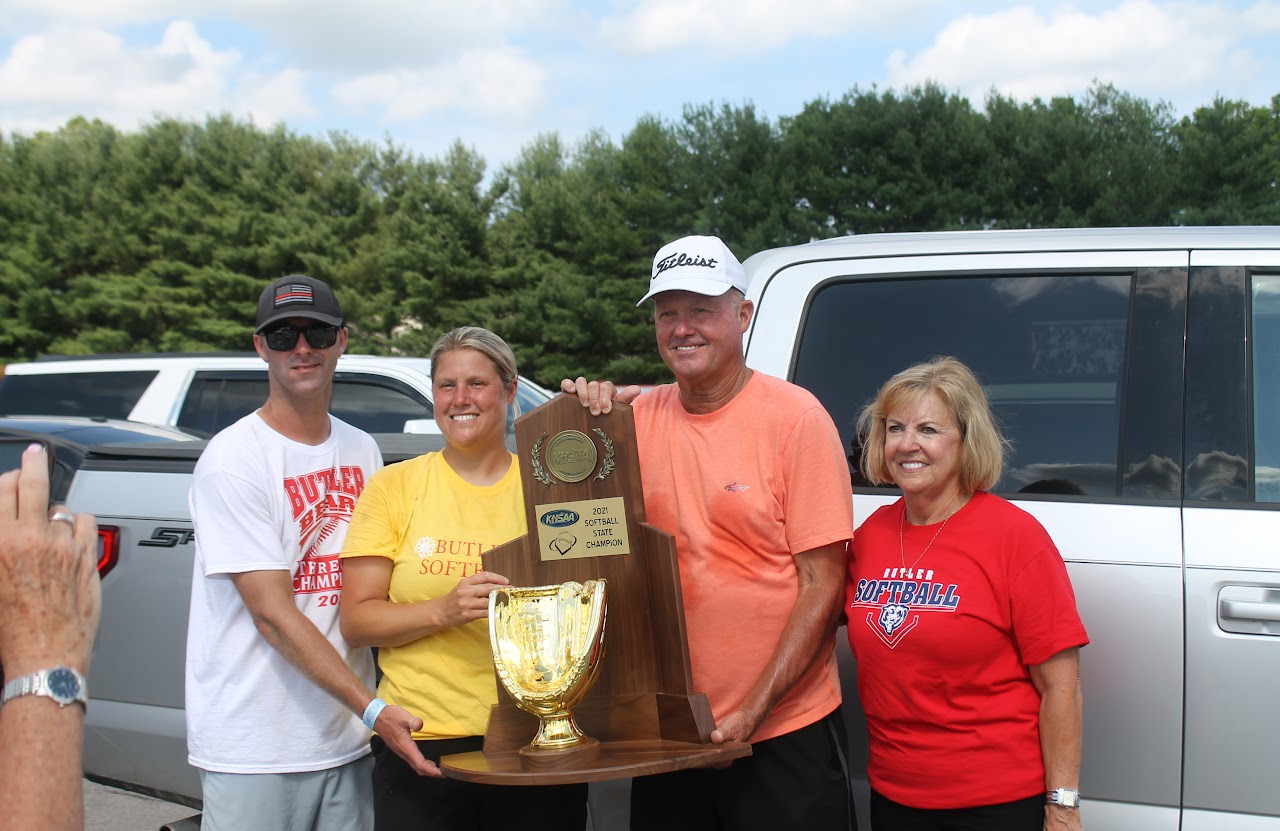 Congratulations to the winning team! They are posing with their trophies and sports equipment, celebrating a successful season.