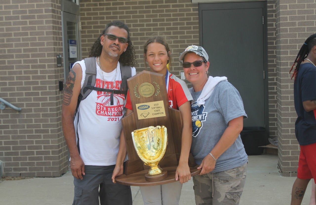 Congratulations to the winning team! They are posing with their trophies and sports equipment, celebrating a successful season.