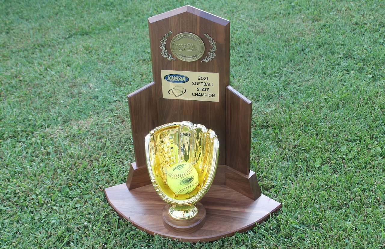 Trophy with a baseball and championship banner on display.