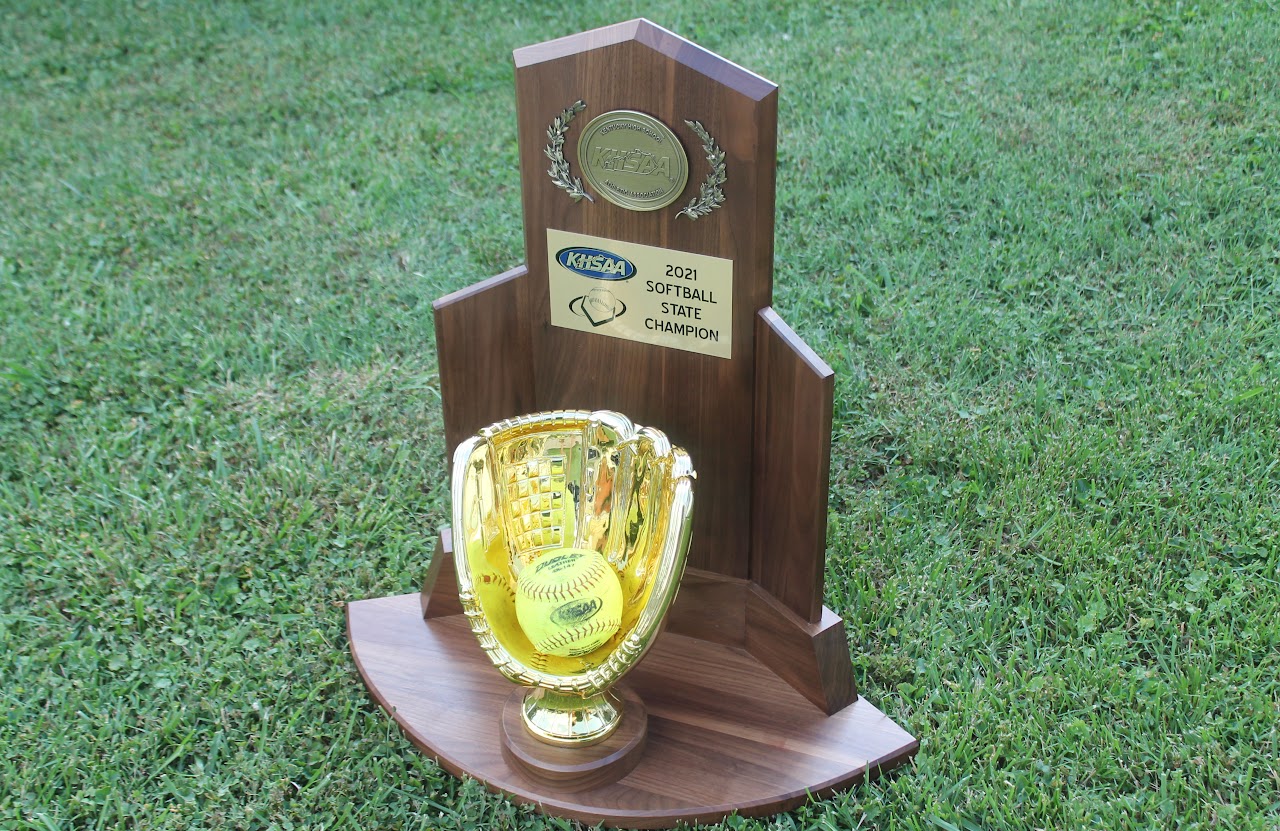 Trophy with a baseball and championship banner on display.