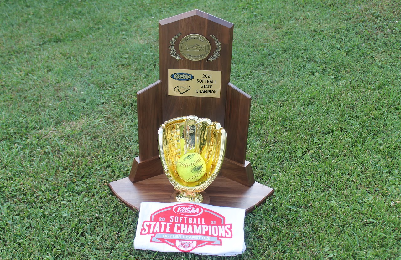 Trophy with a baseball and championship banner on display.