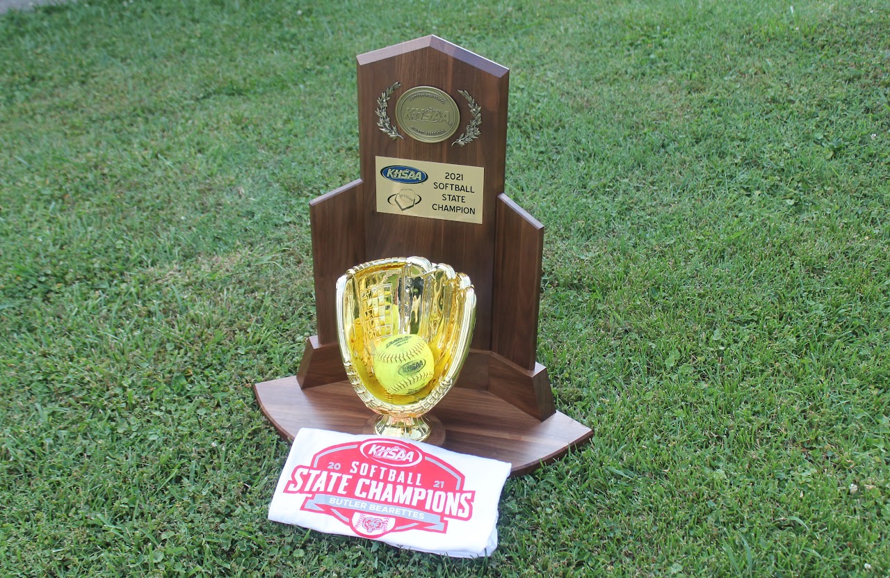 Trophy with a baseball and championship banner on display.