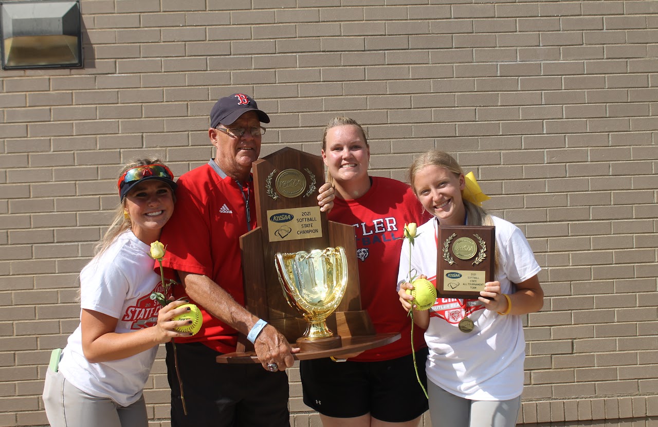 Congratulations to the winning team! They are posing with their trophies and sports equipment, celebrating a successful season.