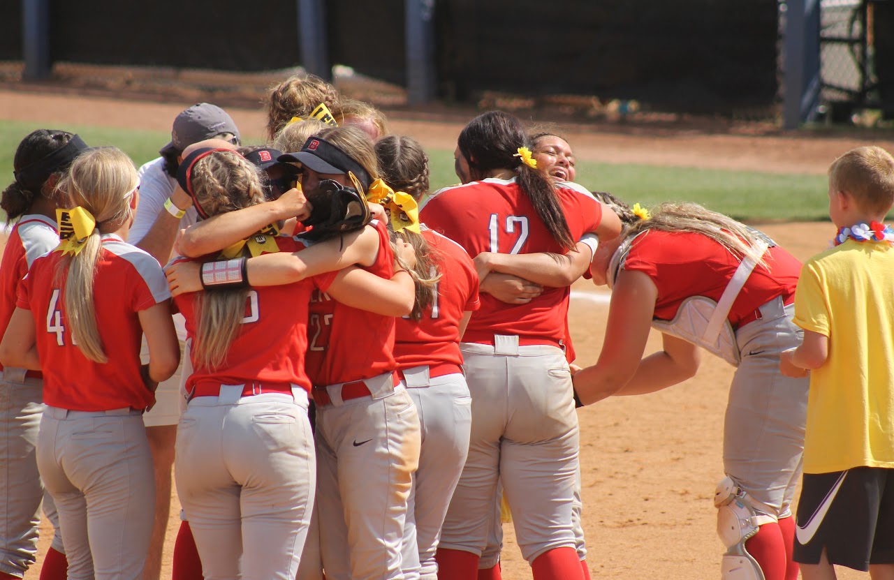 team celebrating a victory hugging