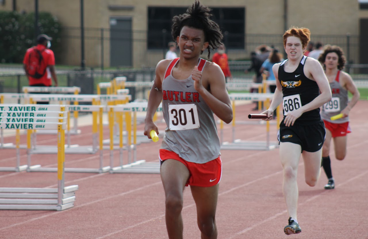 student running on the track field