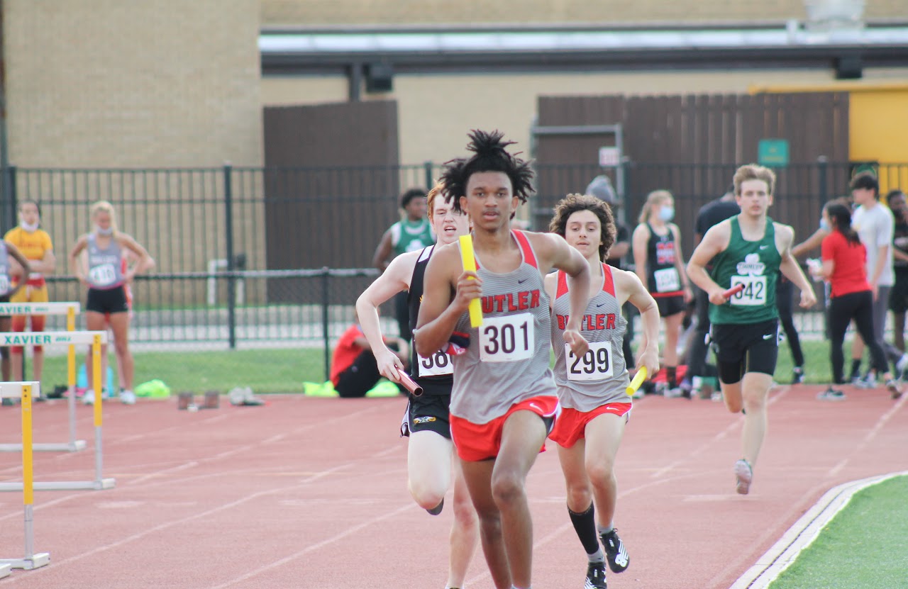 student running on competition with the stick