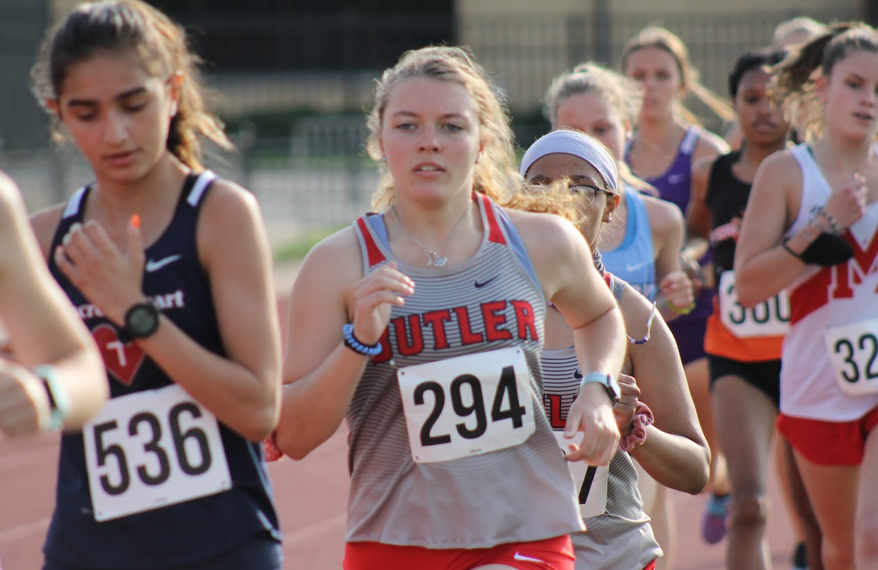 students running on the track field