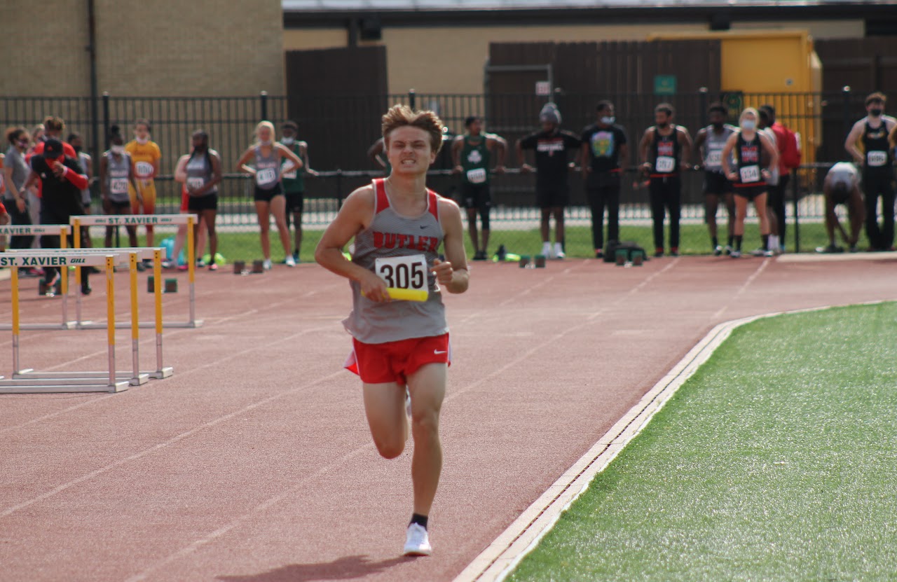 student running on the track field