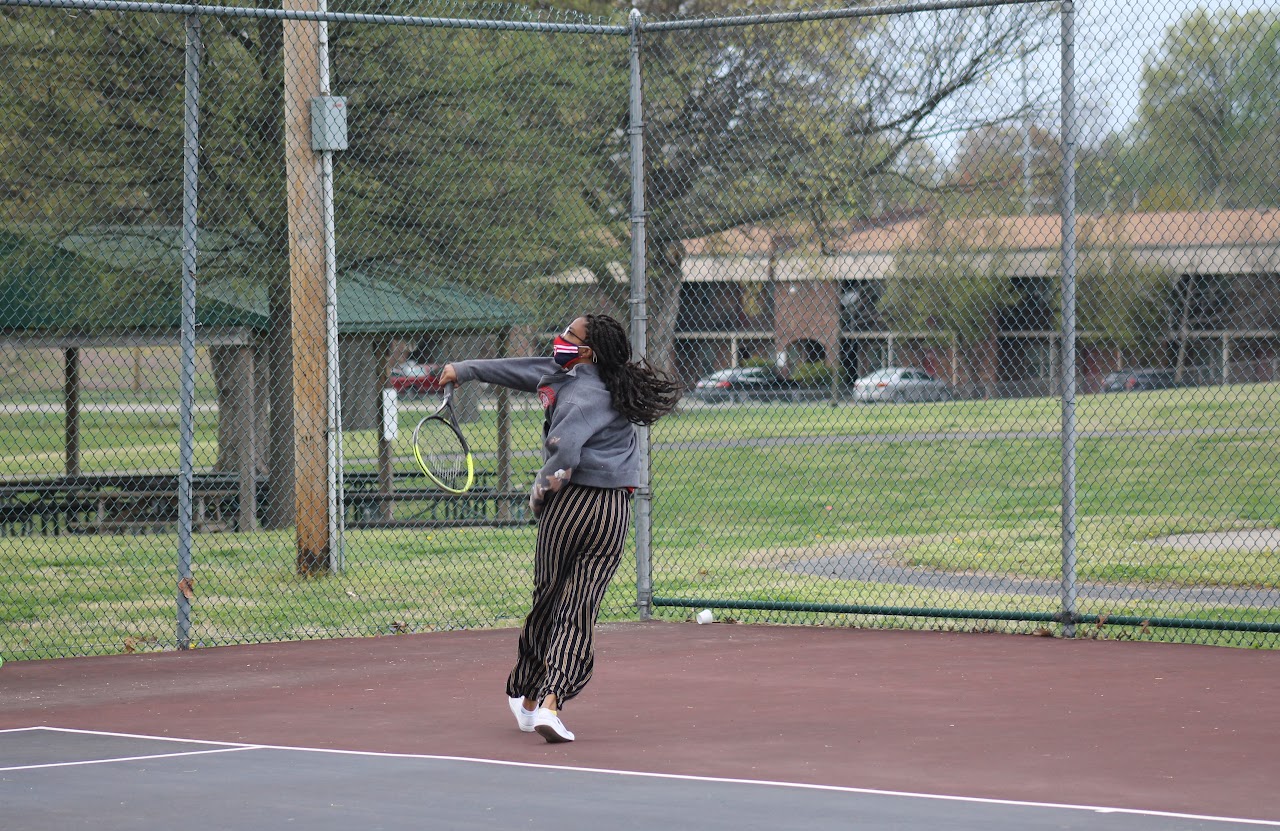 player running and hitting the ball