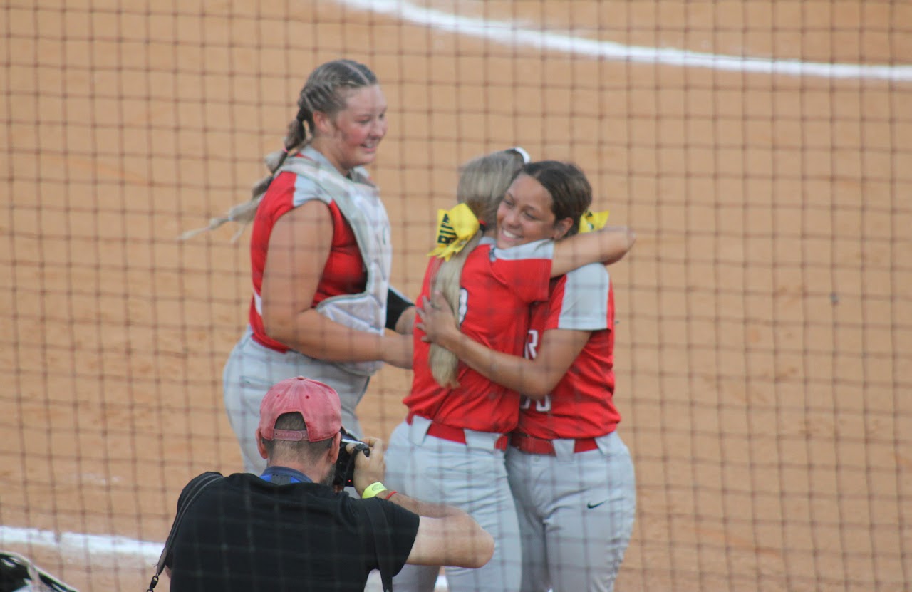 baseball team members hugging after a victory