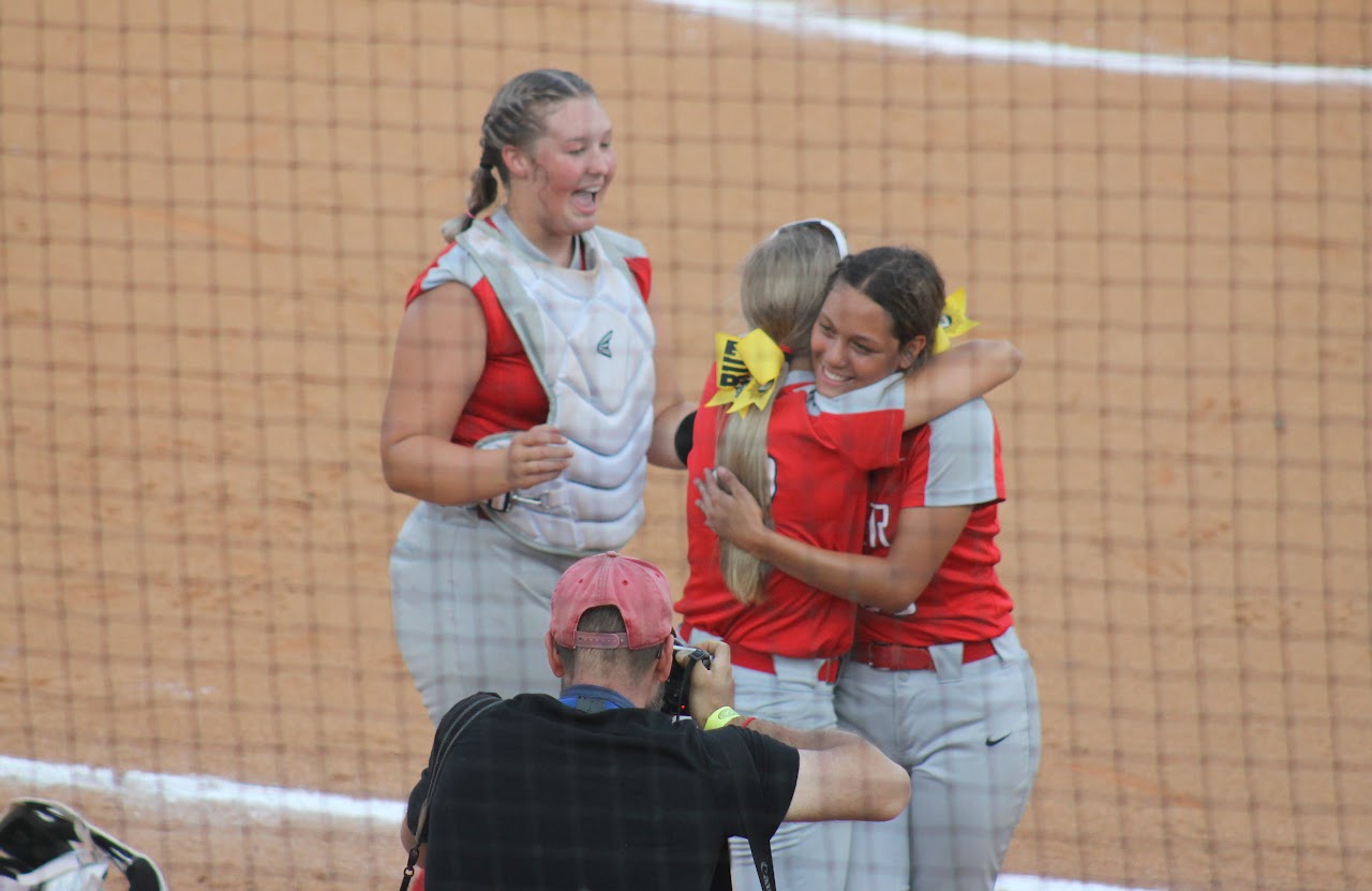 baseball team members hugging after a victory