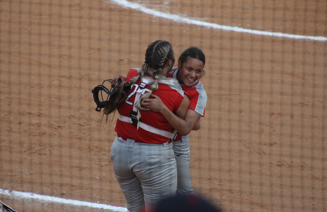 baseball team members hugging after a victory