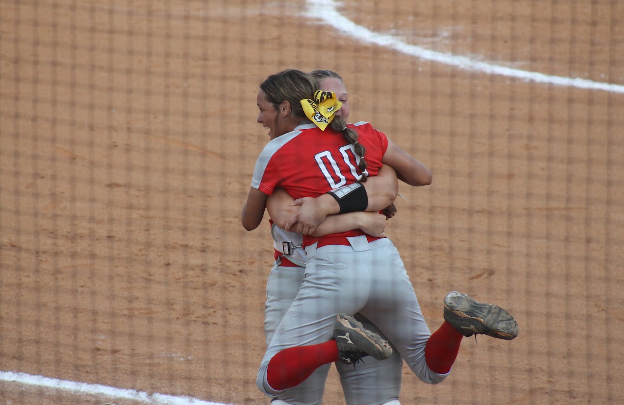 baseball team members hugging after a victory