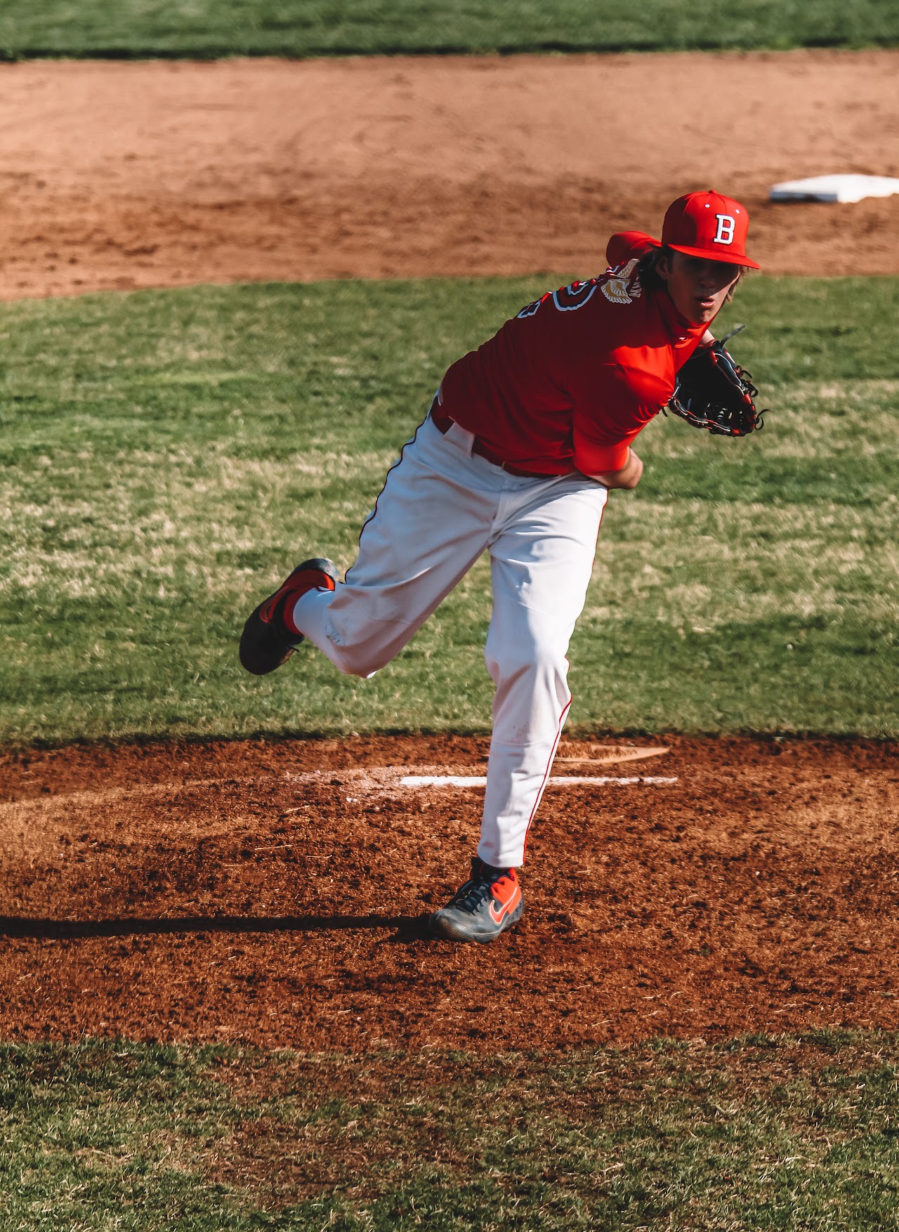 pitcher throwing the ball to the home plate