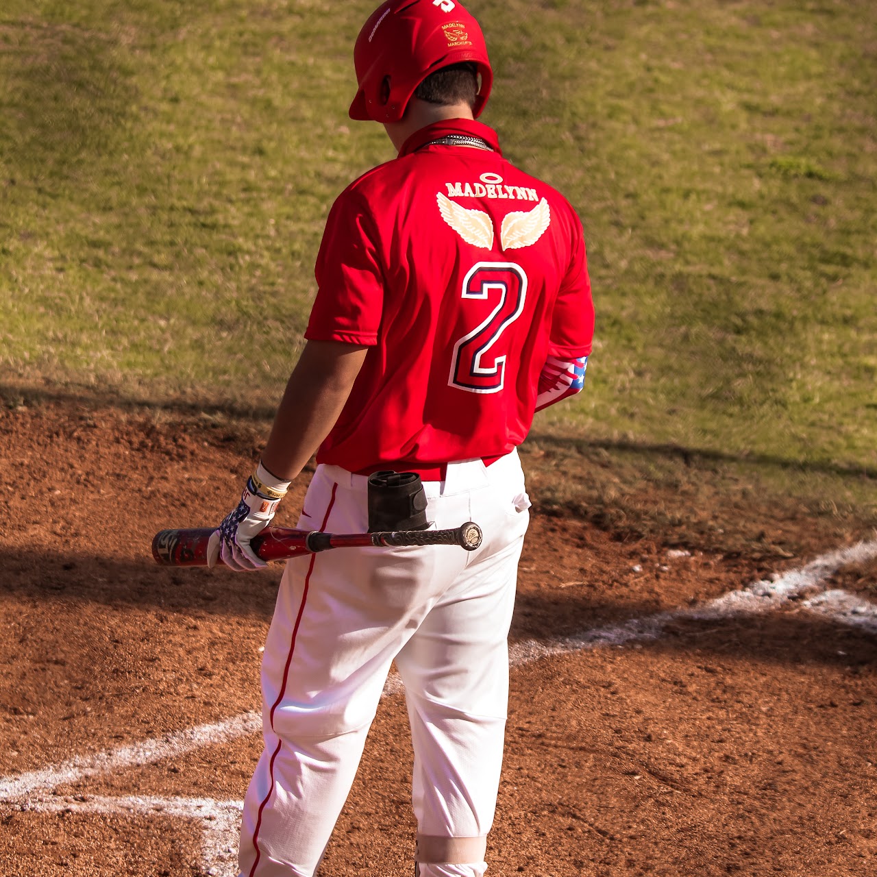 player standing up on the field with the bat