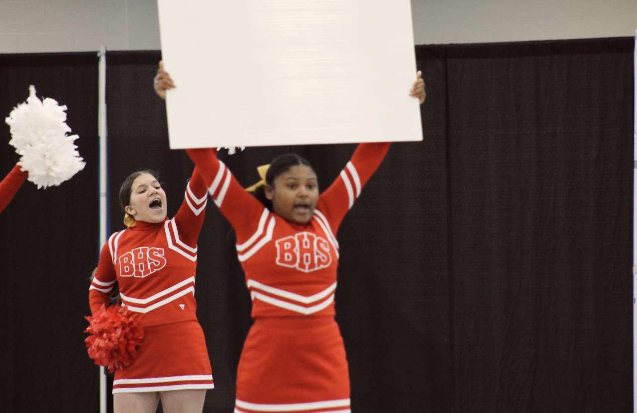 Cheerleaders with a sign