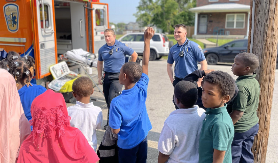 Students listening to paramedics talk