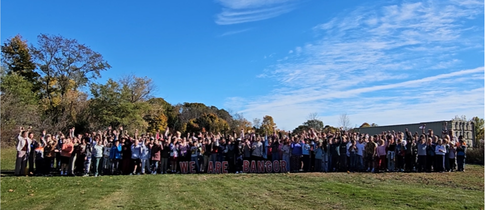 Mary Snow students and staff celebrate Maine Apple Crunch Day on the lawn of the school.