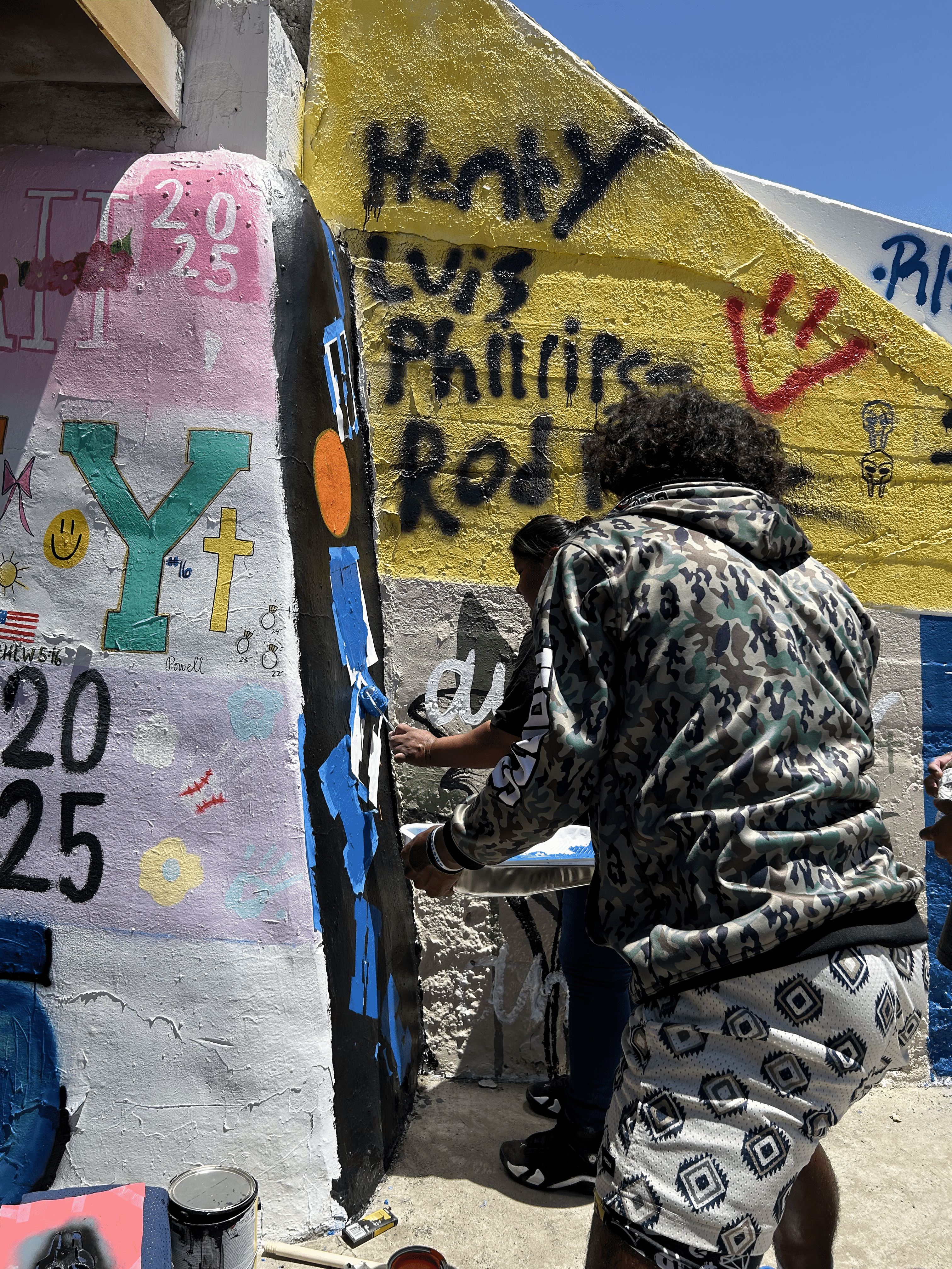 Students painting underpass.