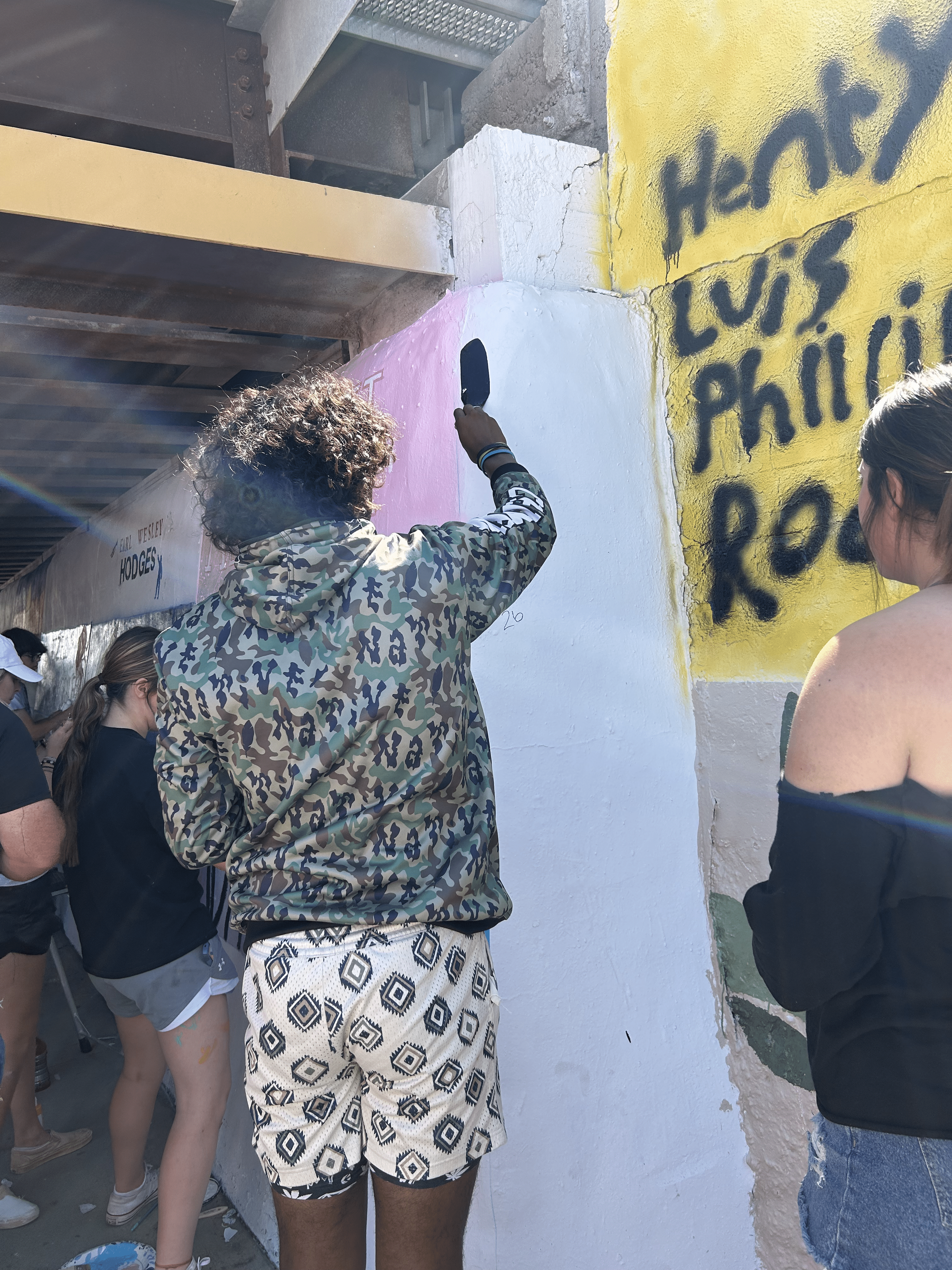 Students painting underpass.