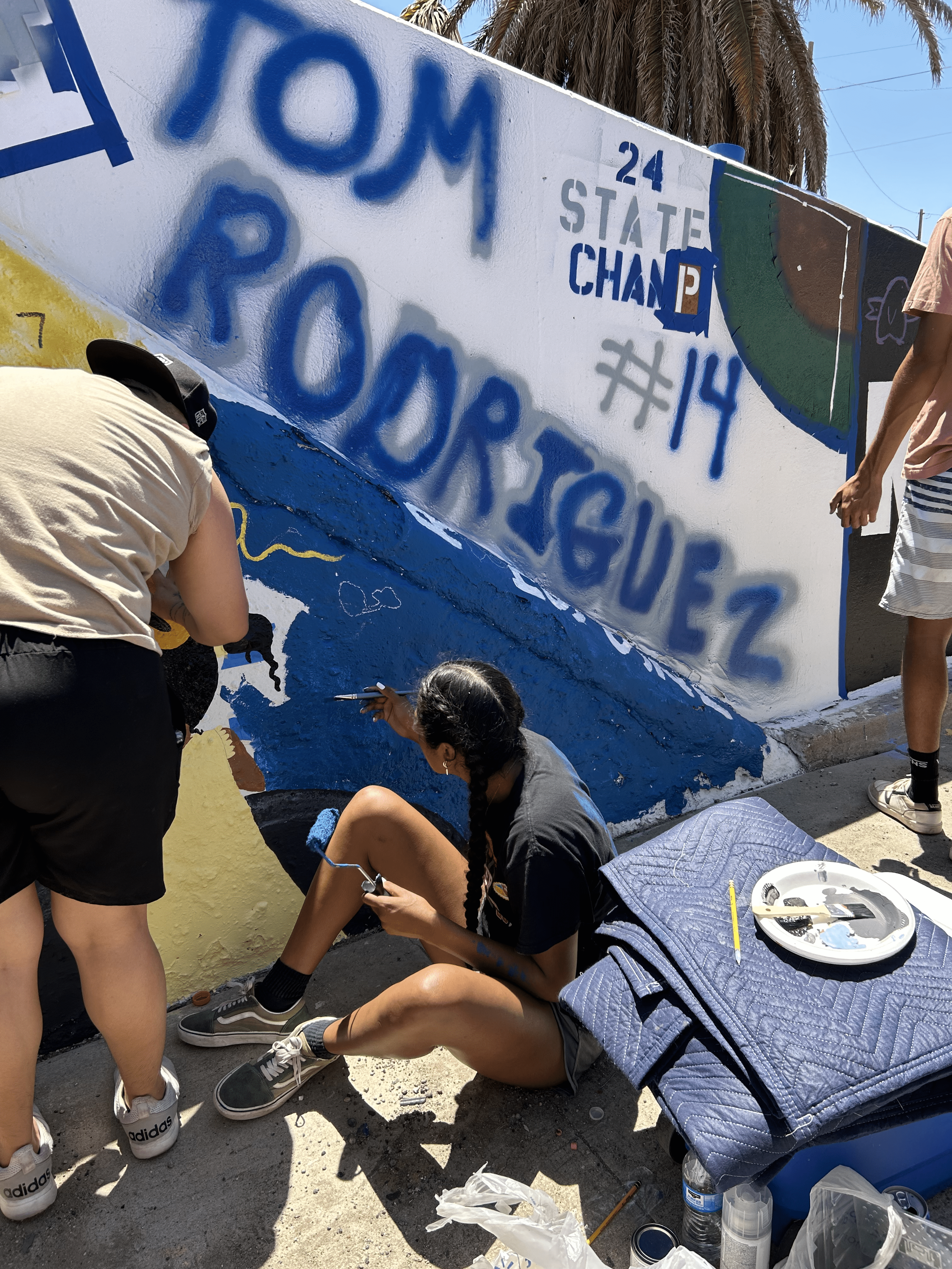 Students painting underpass.