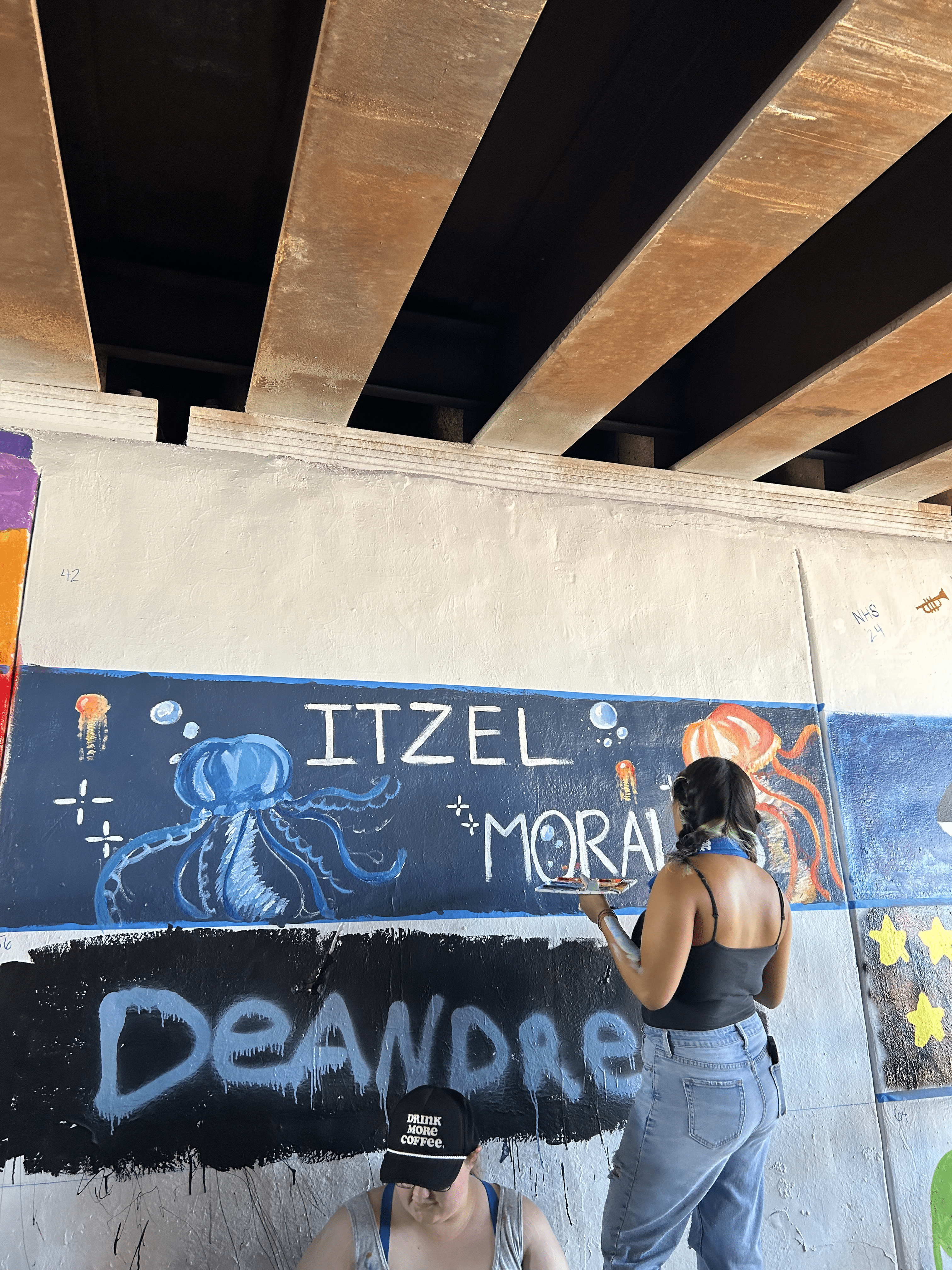 Students painting underpass.