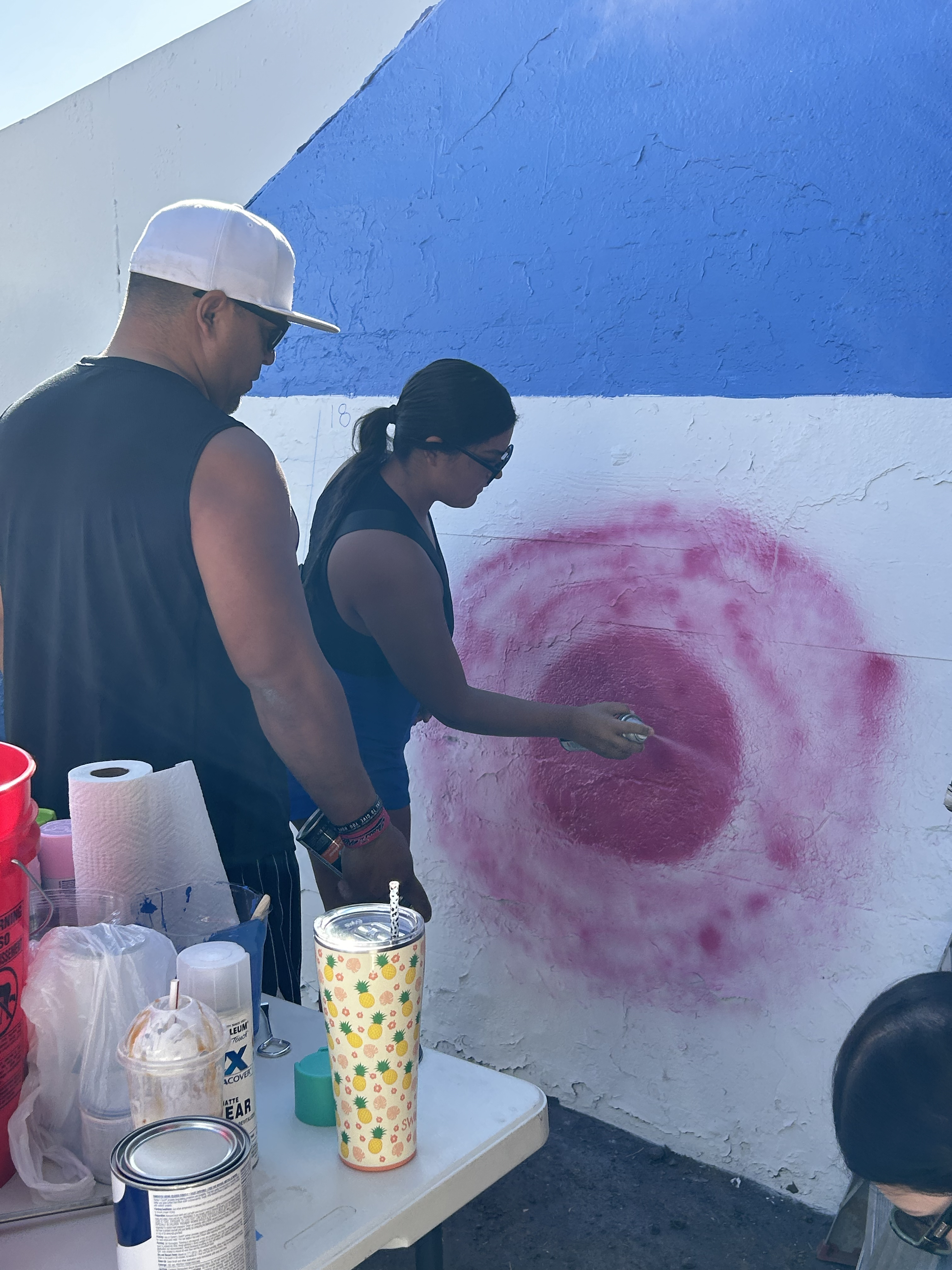 Students painting underpass.