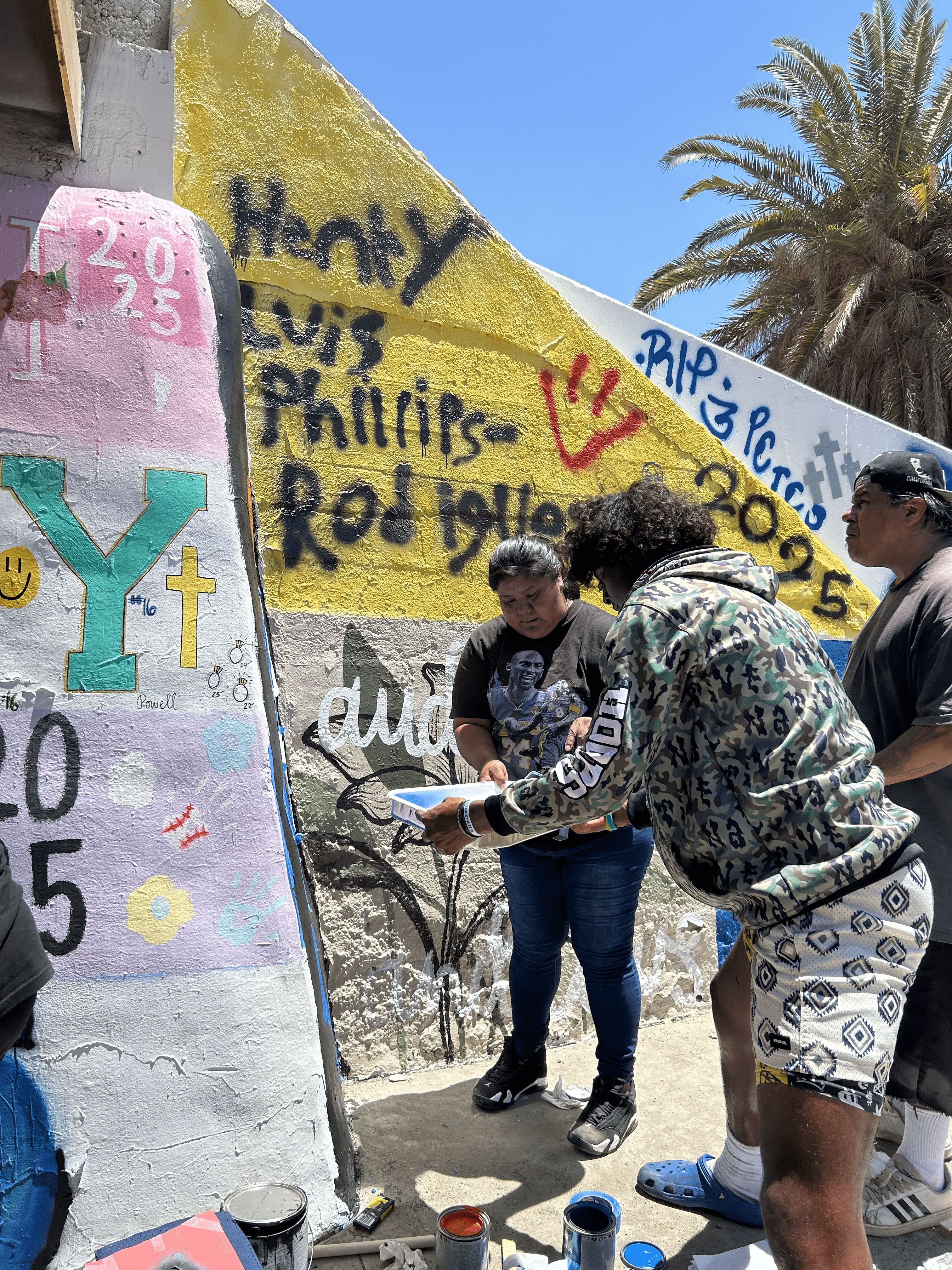 Students painting underpass.