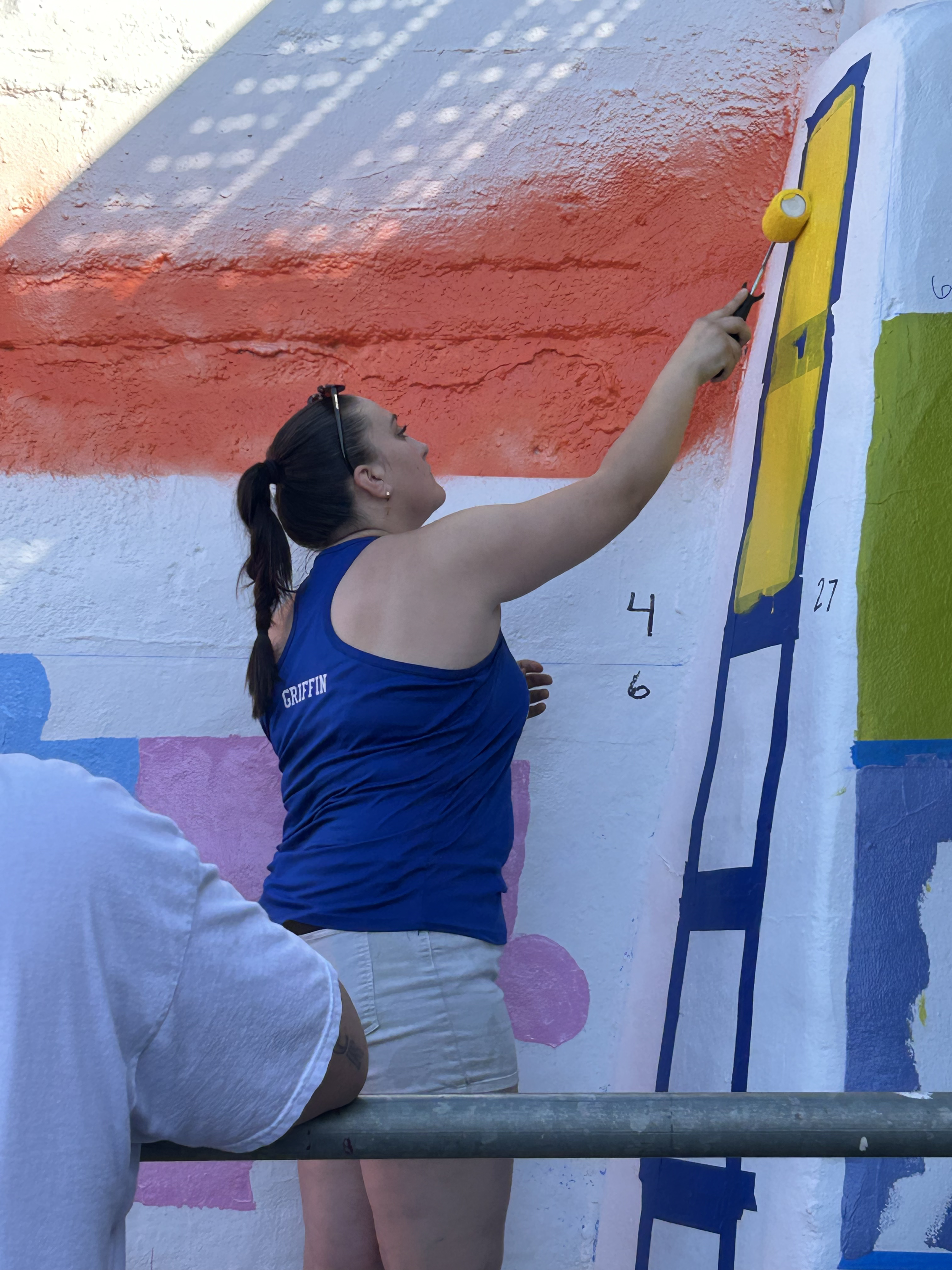 Students painting underpass.