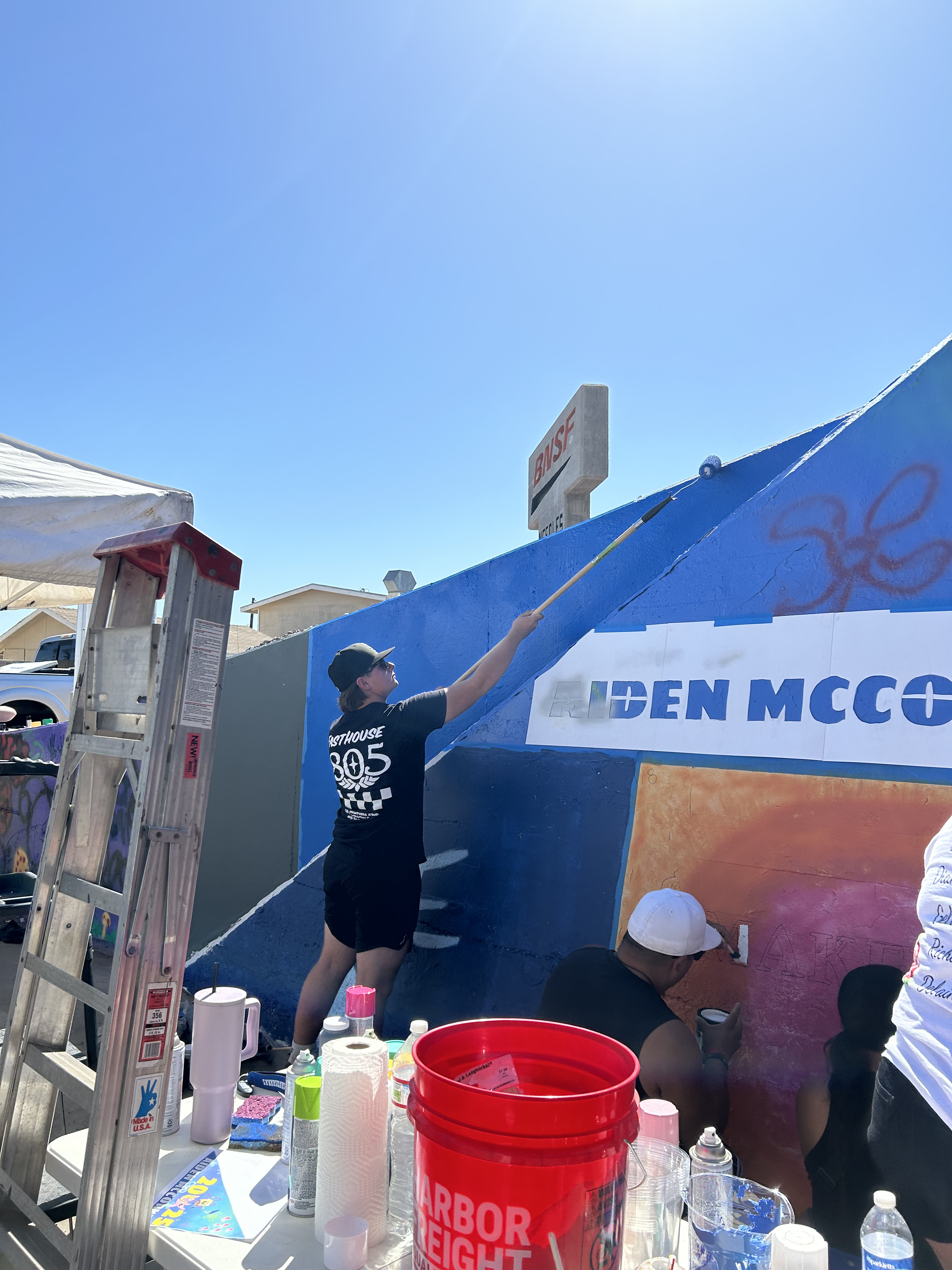 Students painting underpass.