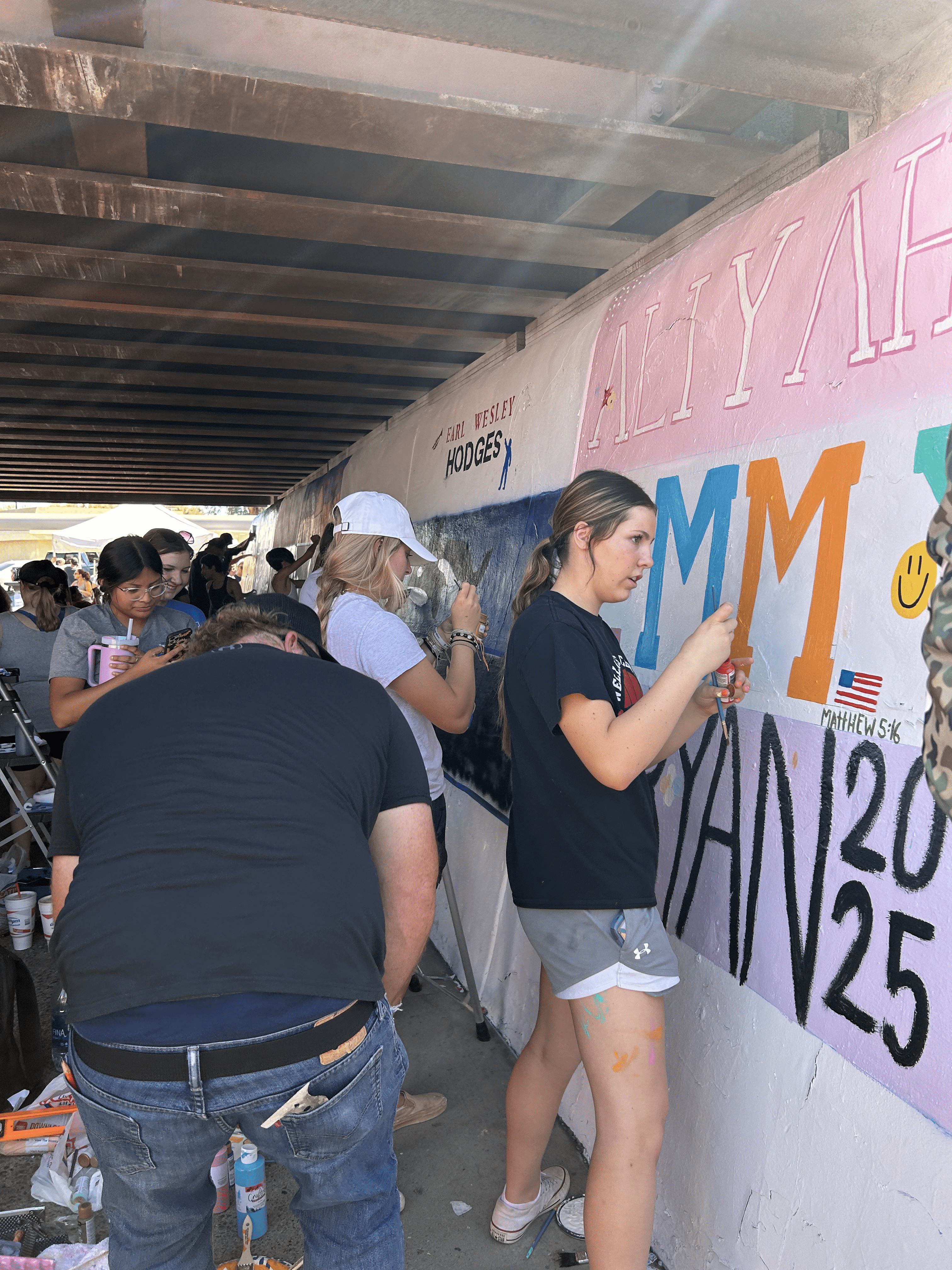 Students painting underpass.