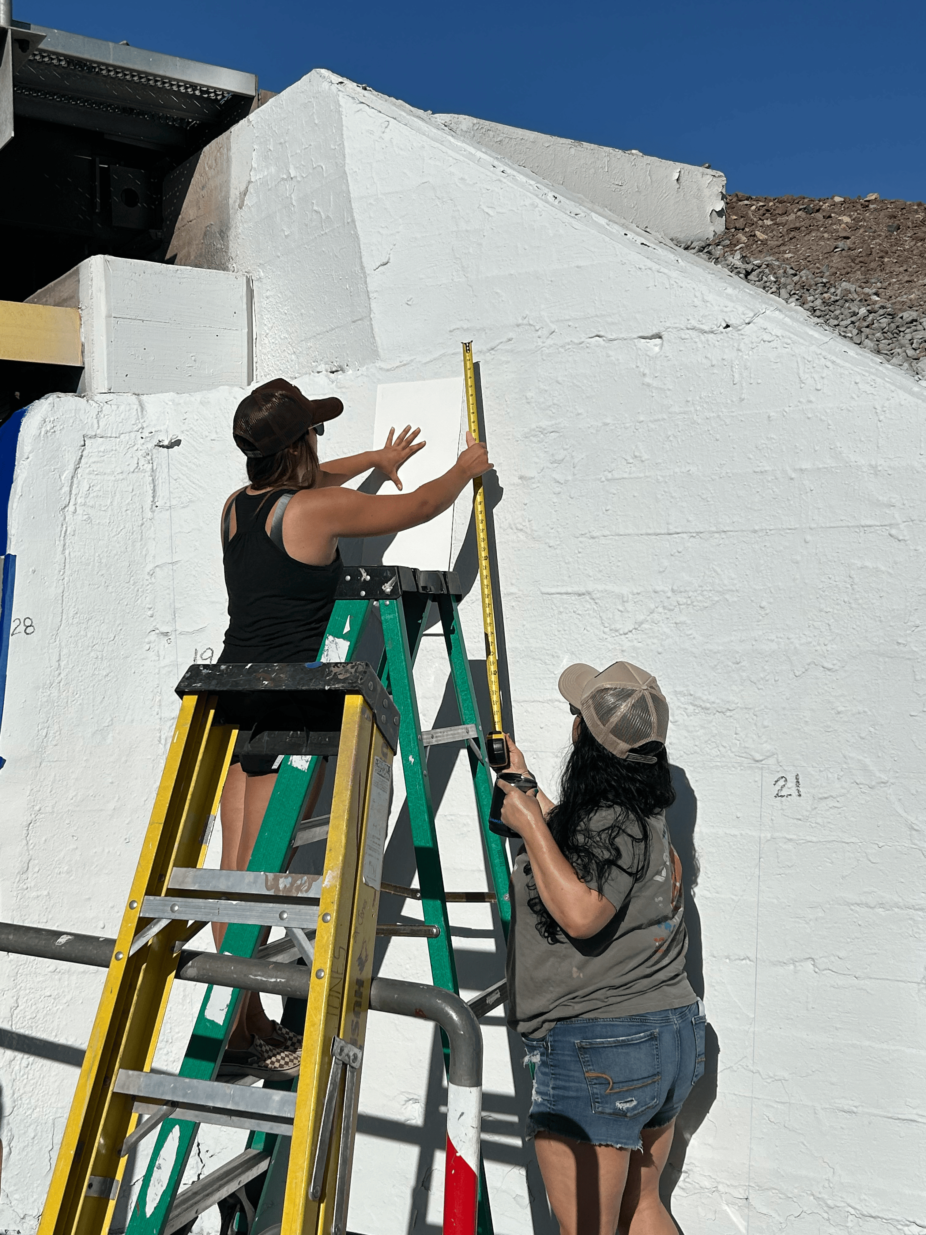 Students painting underpass.