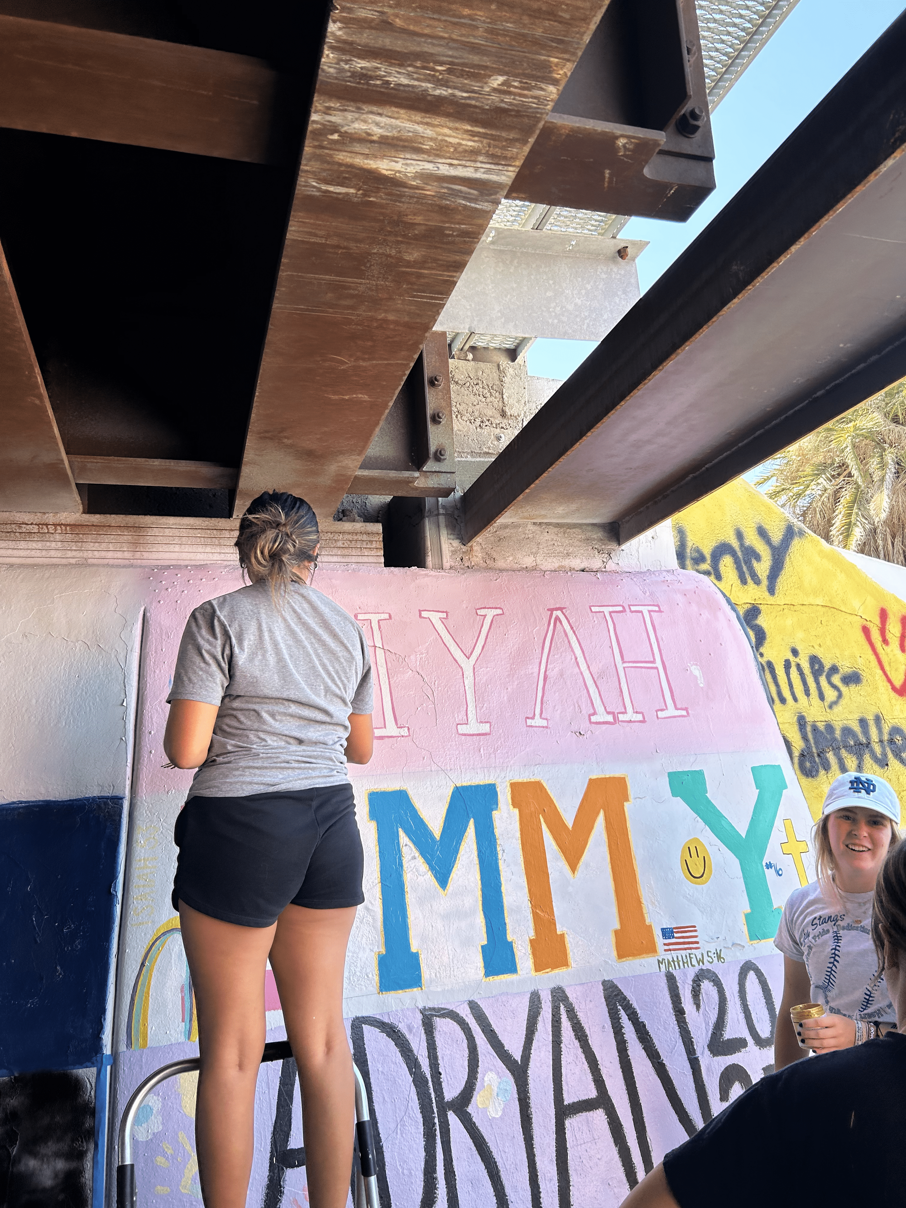 Students painting underpass.